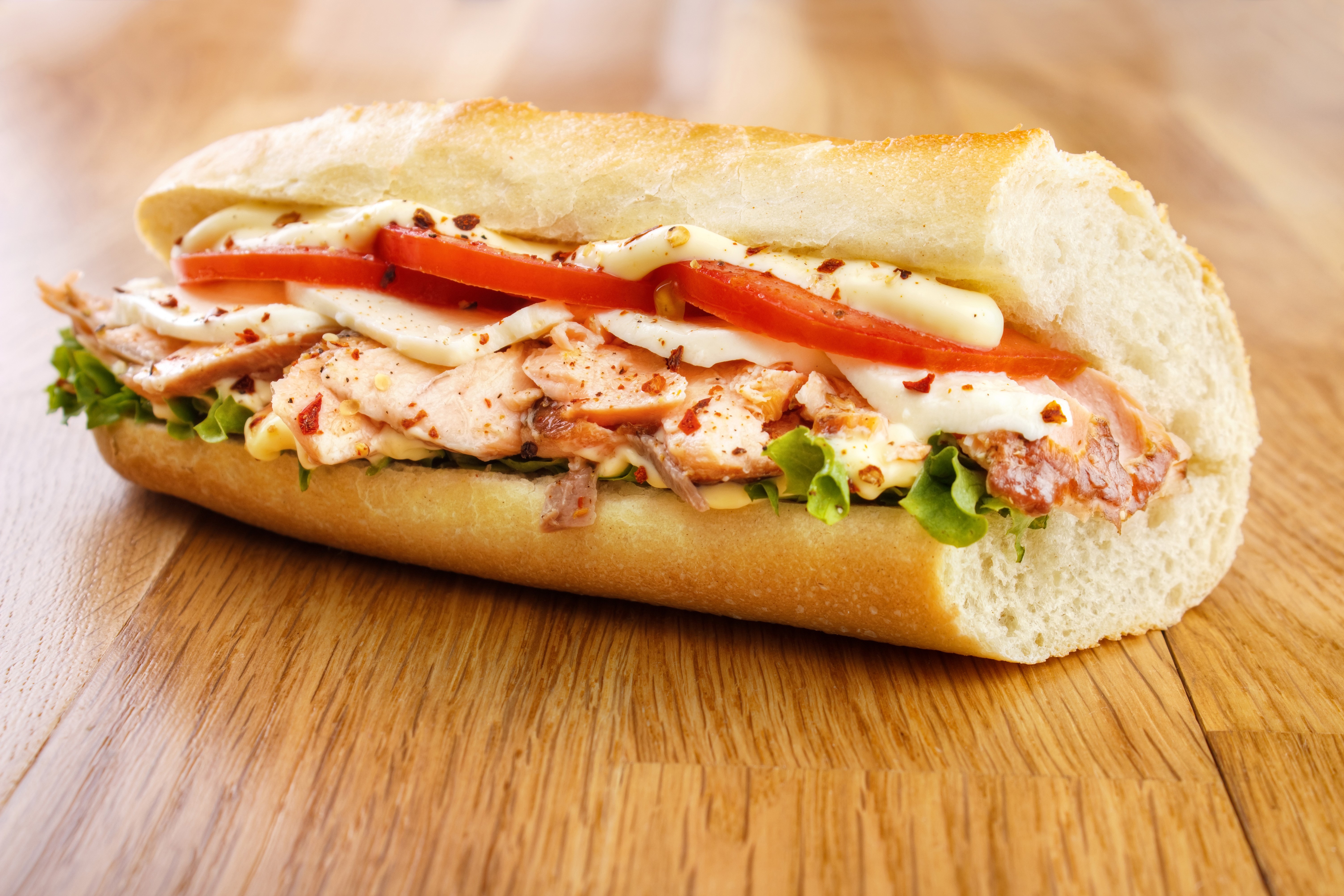 Sandwich with salmon, tomatoes, and lettuce on a baguette HD Wallpaper