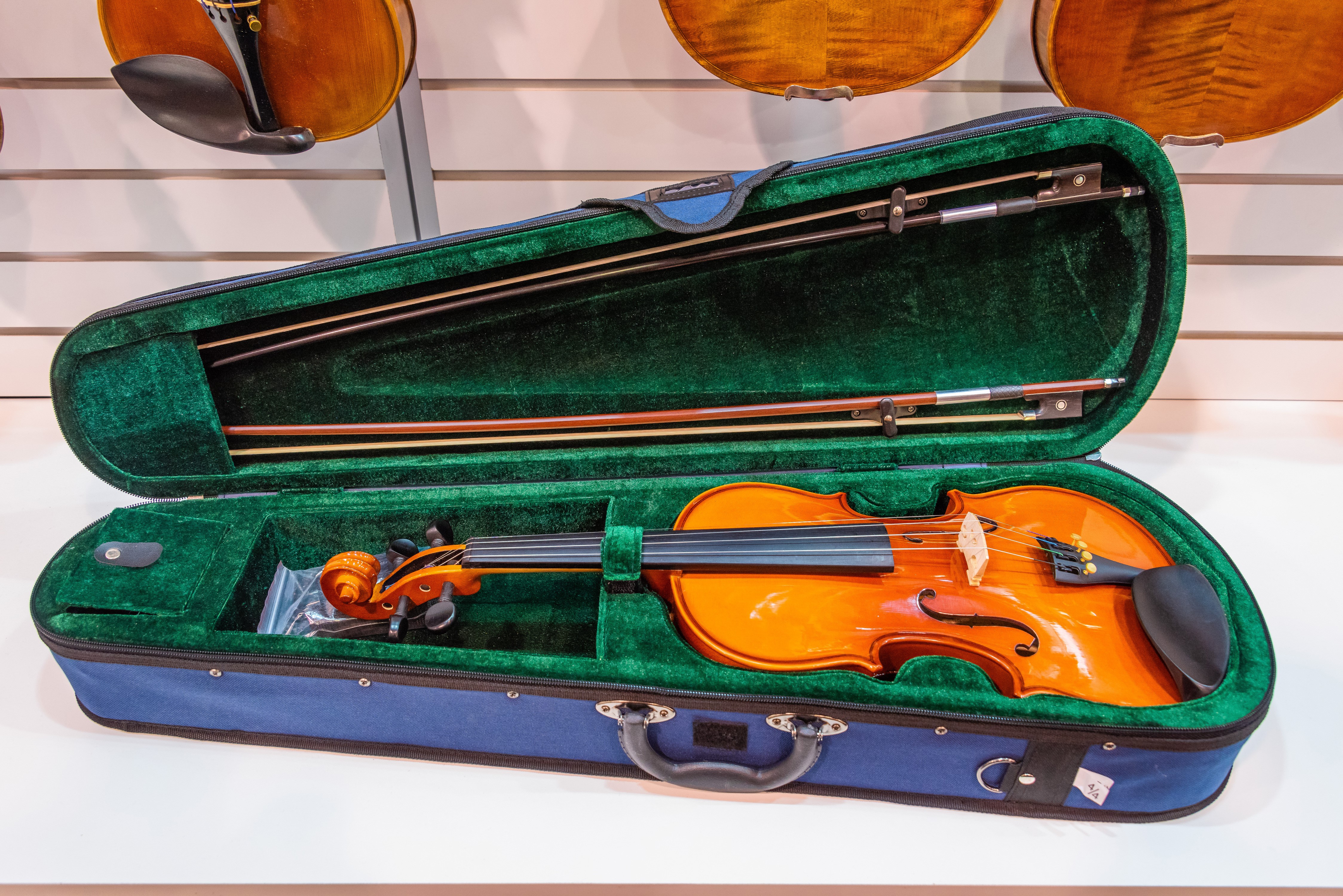 Violin in a blue and green case with bows HD Wallpaper