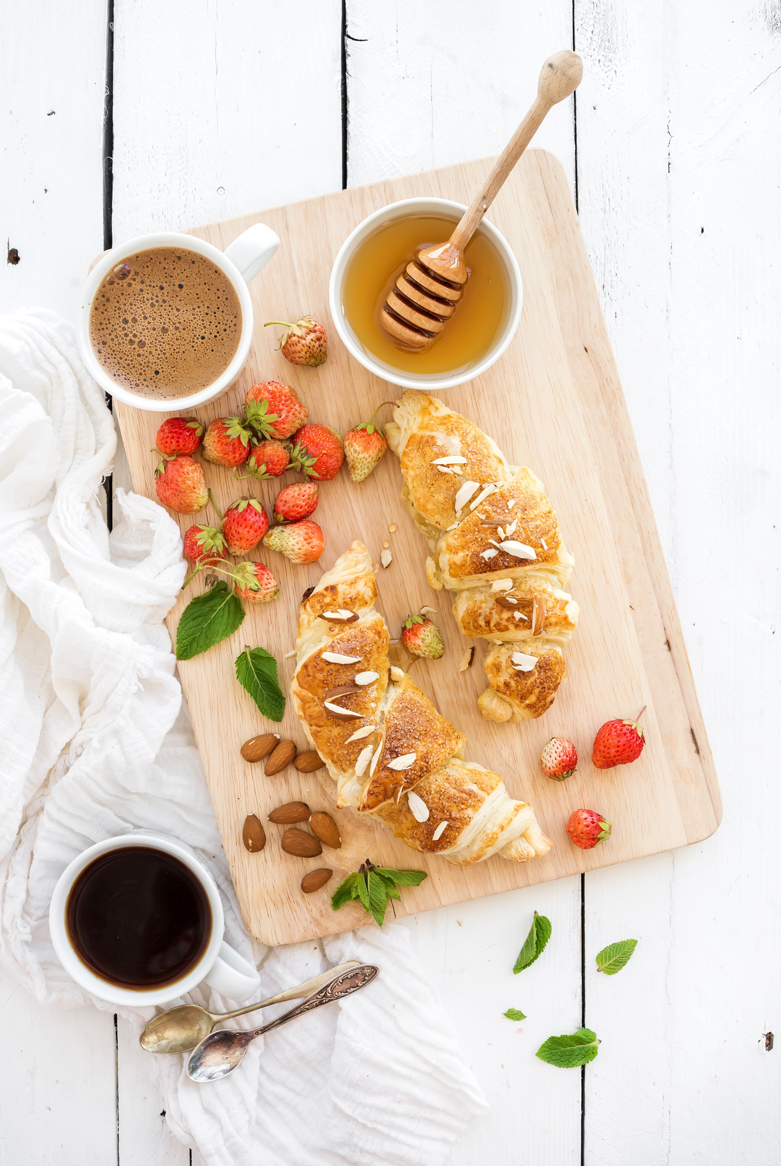 Croissants with strawberries, coffee, and honey on a cutting board HD Phone Wallpaper