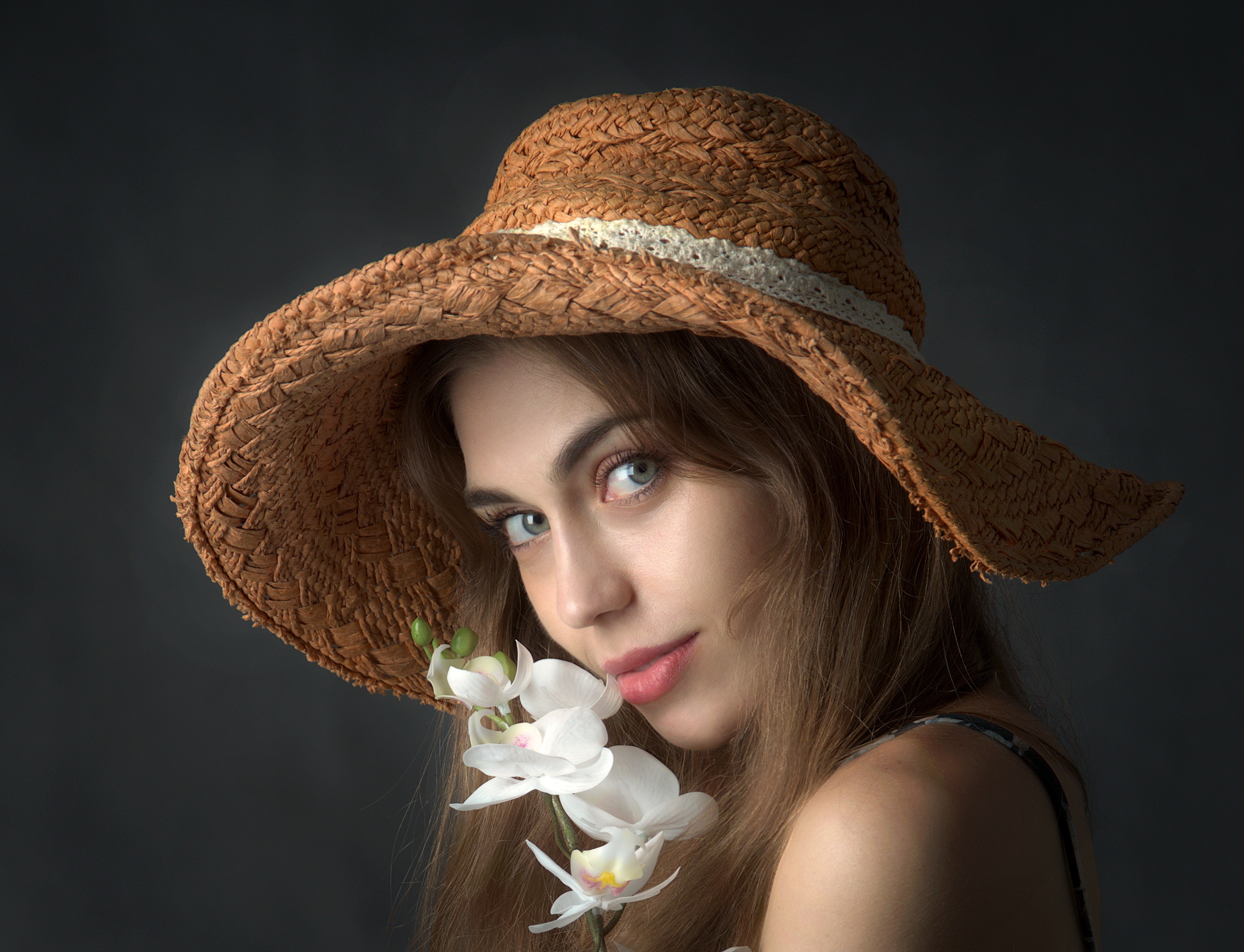 Woman in straw hat with orchid HD Wallpaper