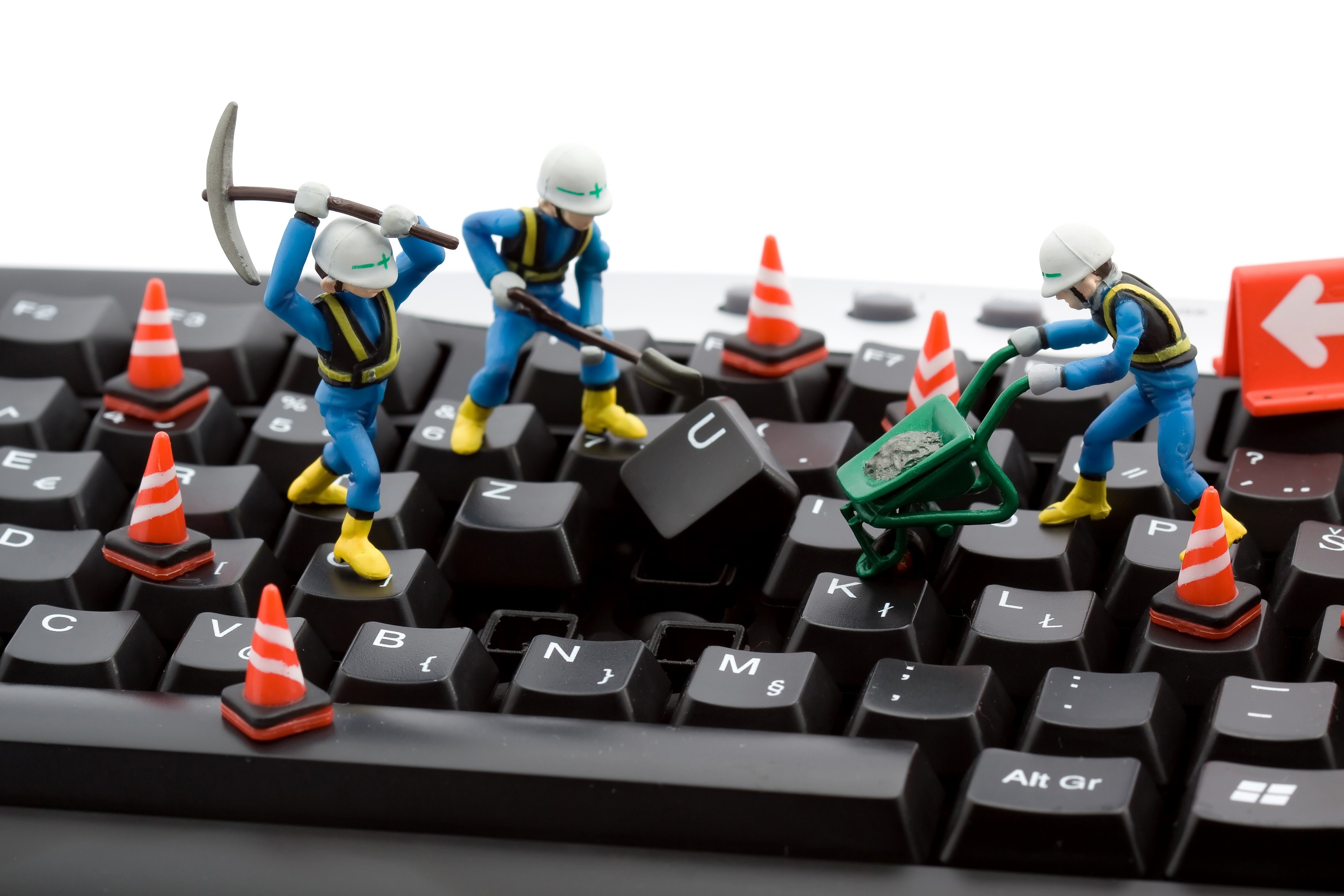 Miniature construction workers on a keyboard HD Wallpaper