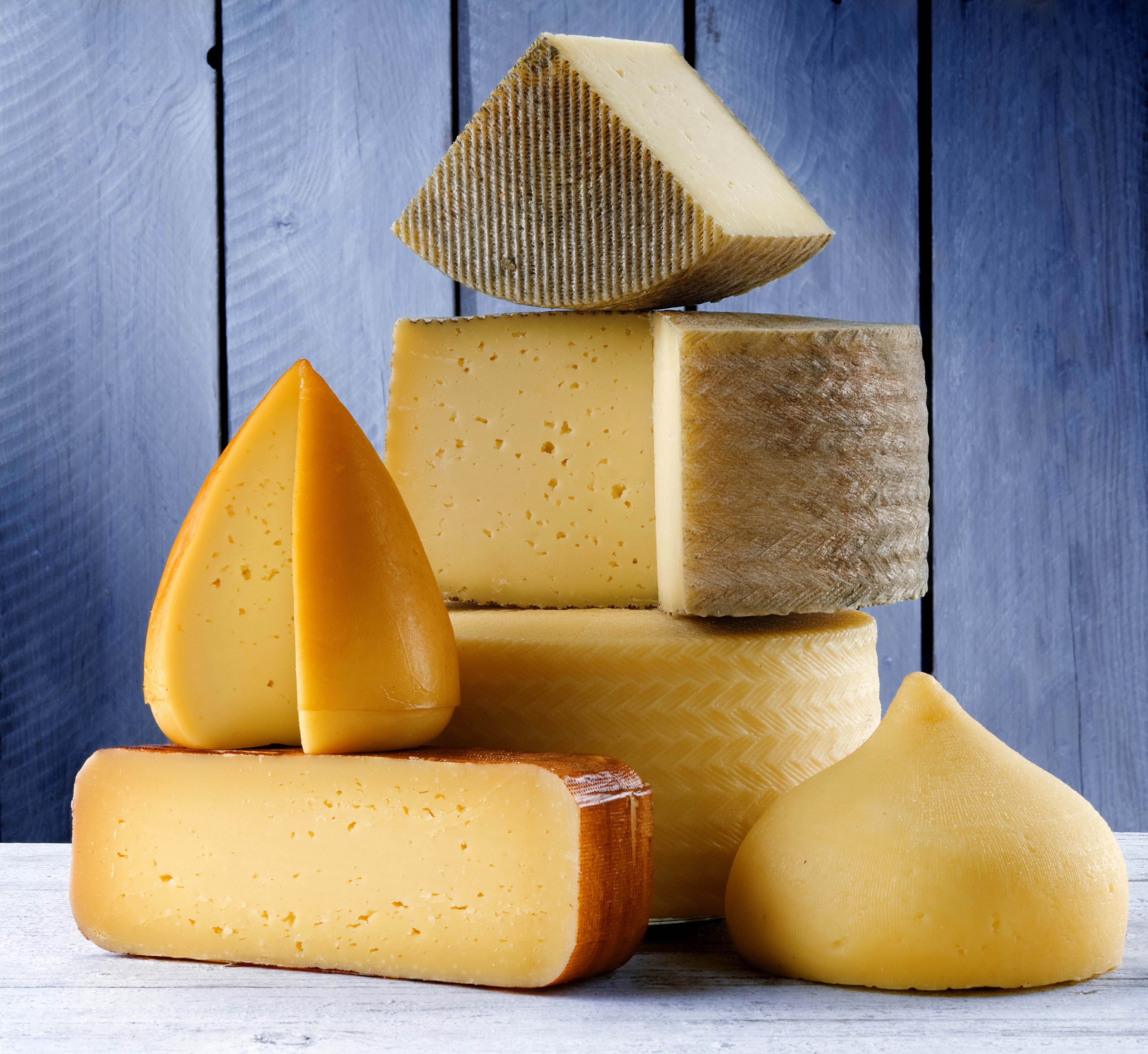 Cheese assortment on a blue wooden background HD Wallpaper