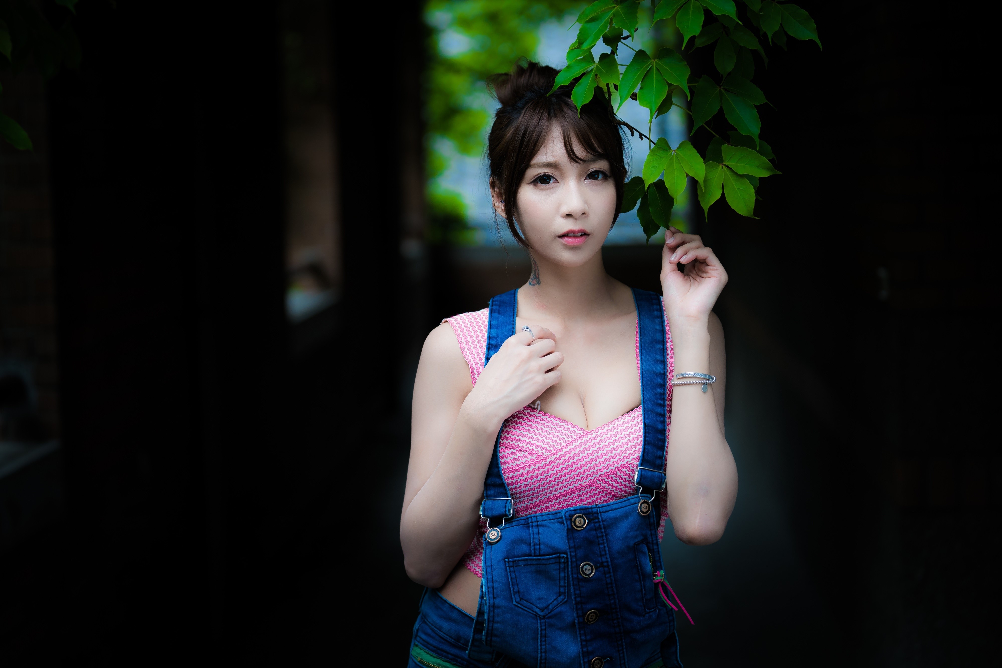 4K Portrait of Brunette Asian Girl with Green Leaves HD Wallpaper