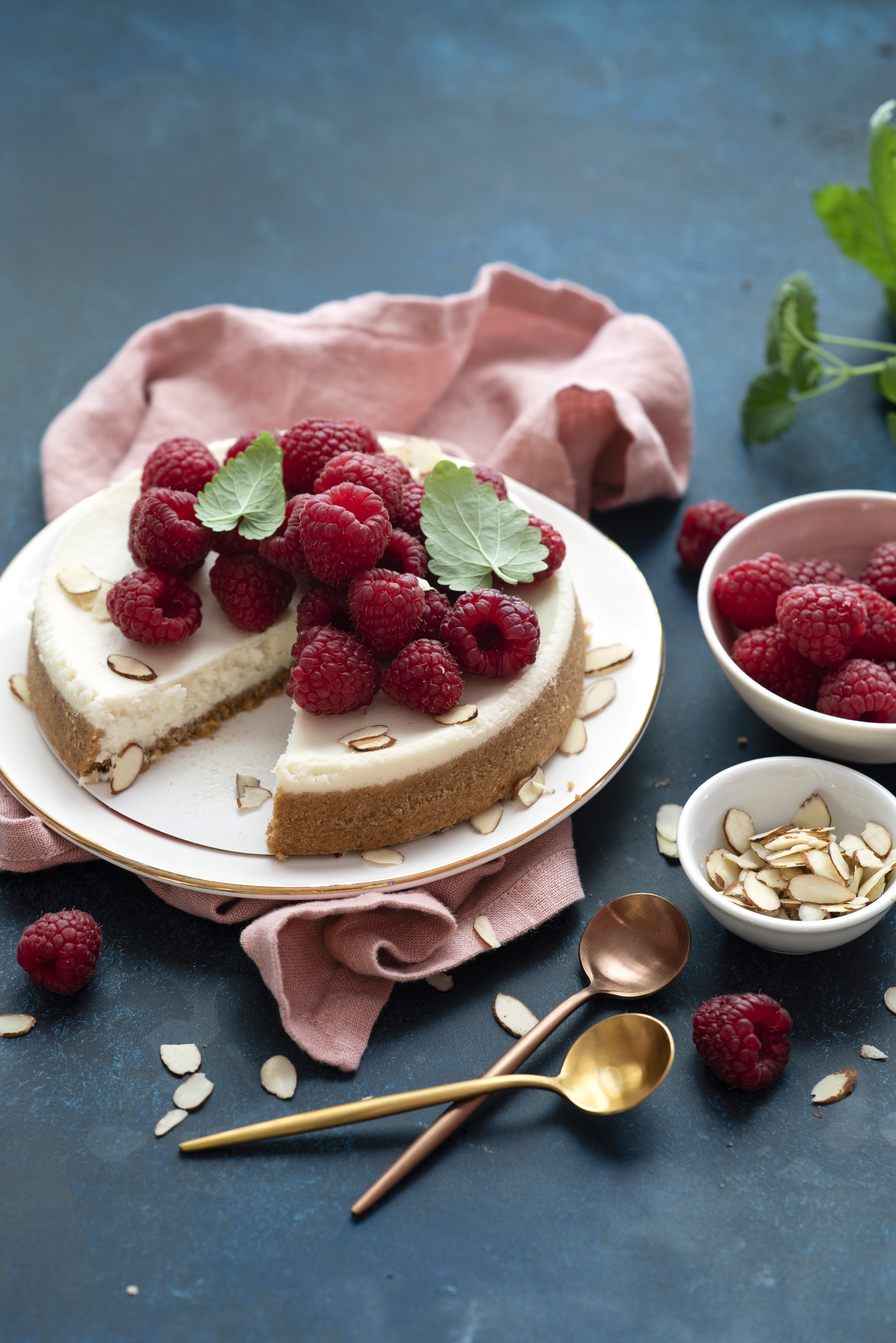 Cheesecake with raspberries and almonds on a plate HD Phone Wallpaper