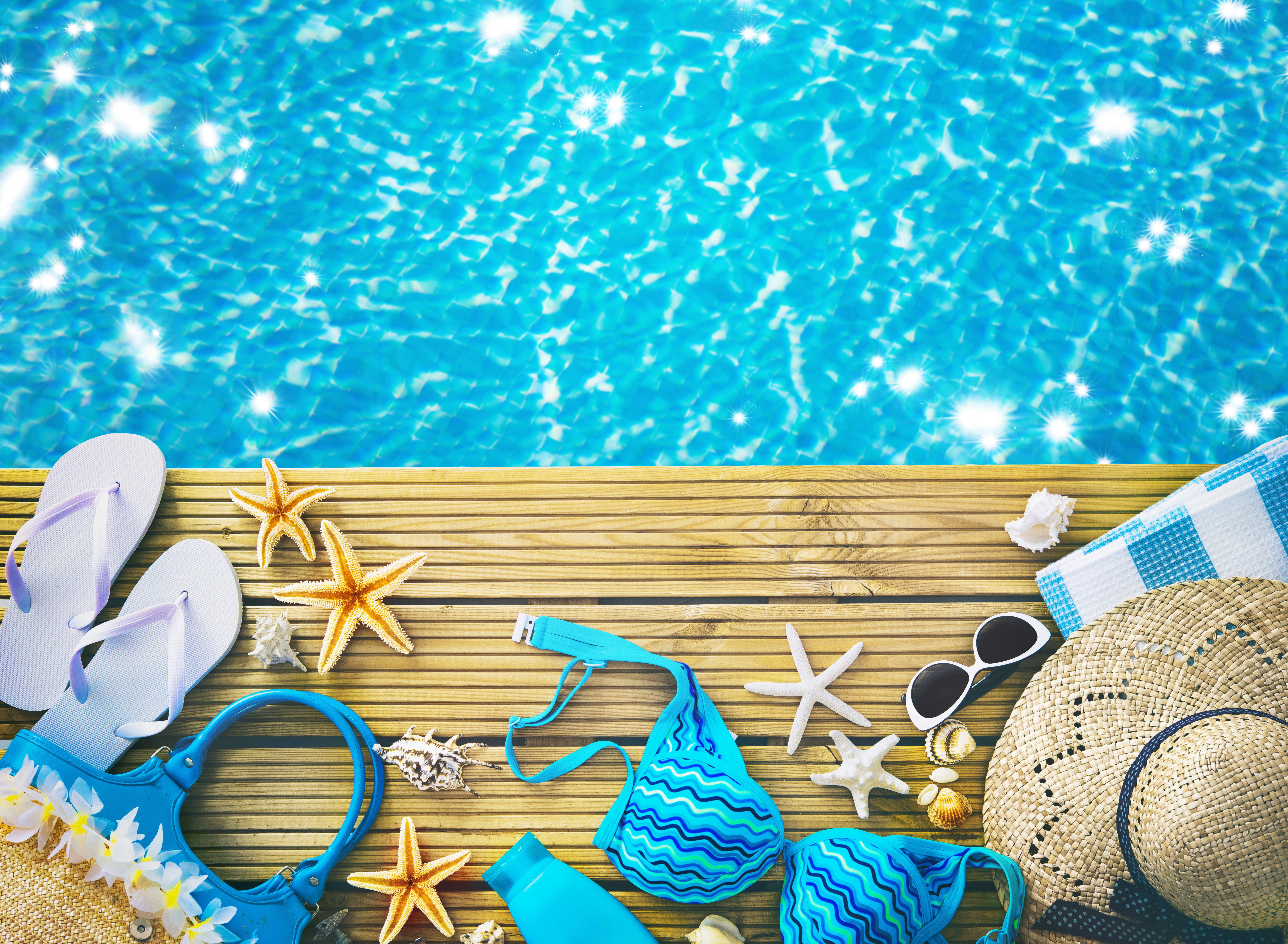 Summer poolside accessories with flip-flops, bikini, and hat HD Wallpaper