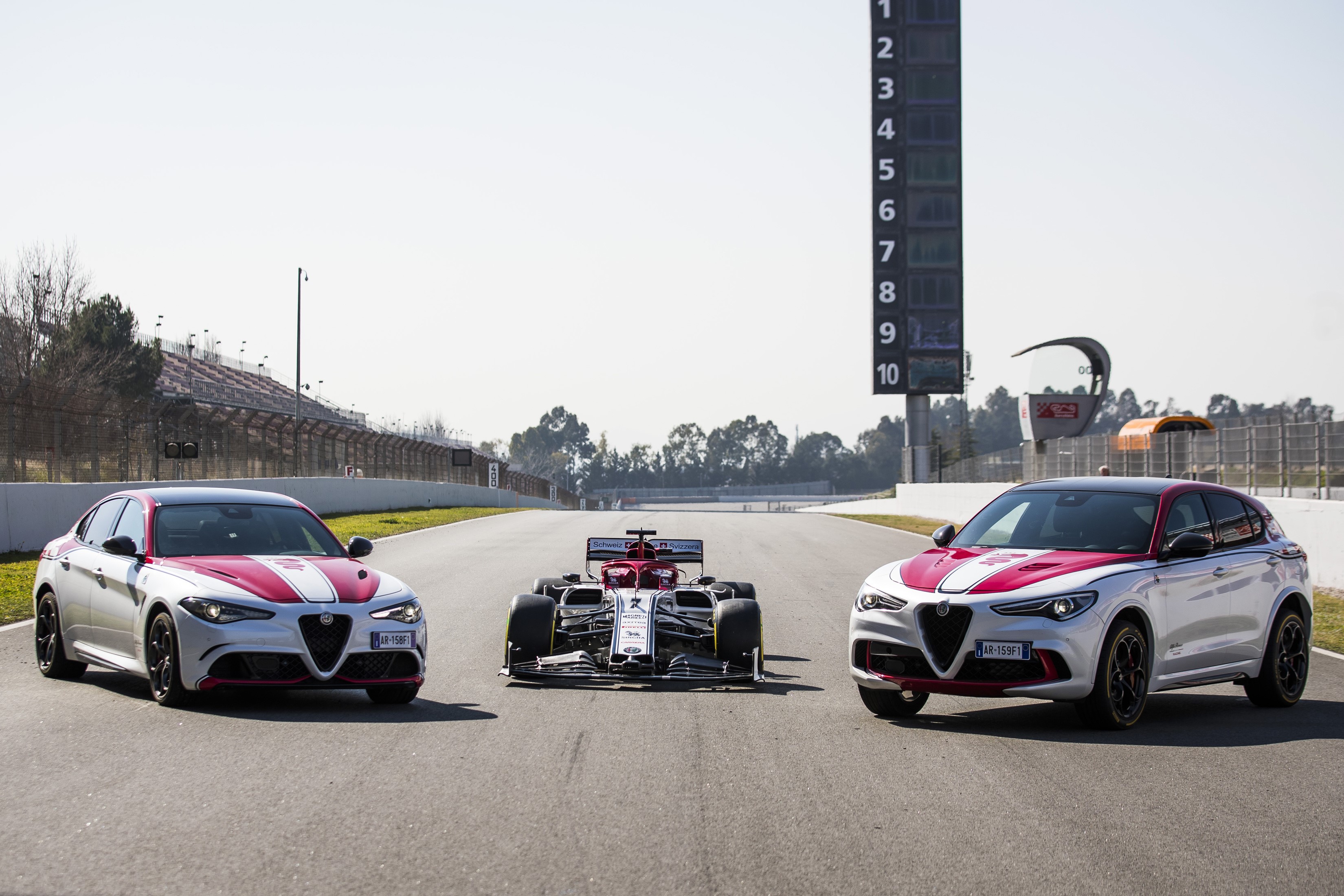 Alfa Romeo Giulia and Stelvio Quadrifoglio with F1 car HD Wallpaper