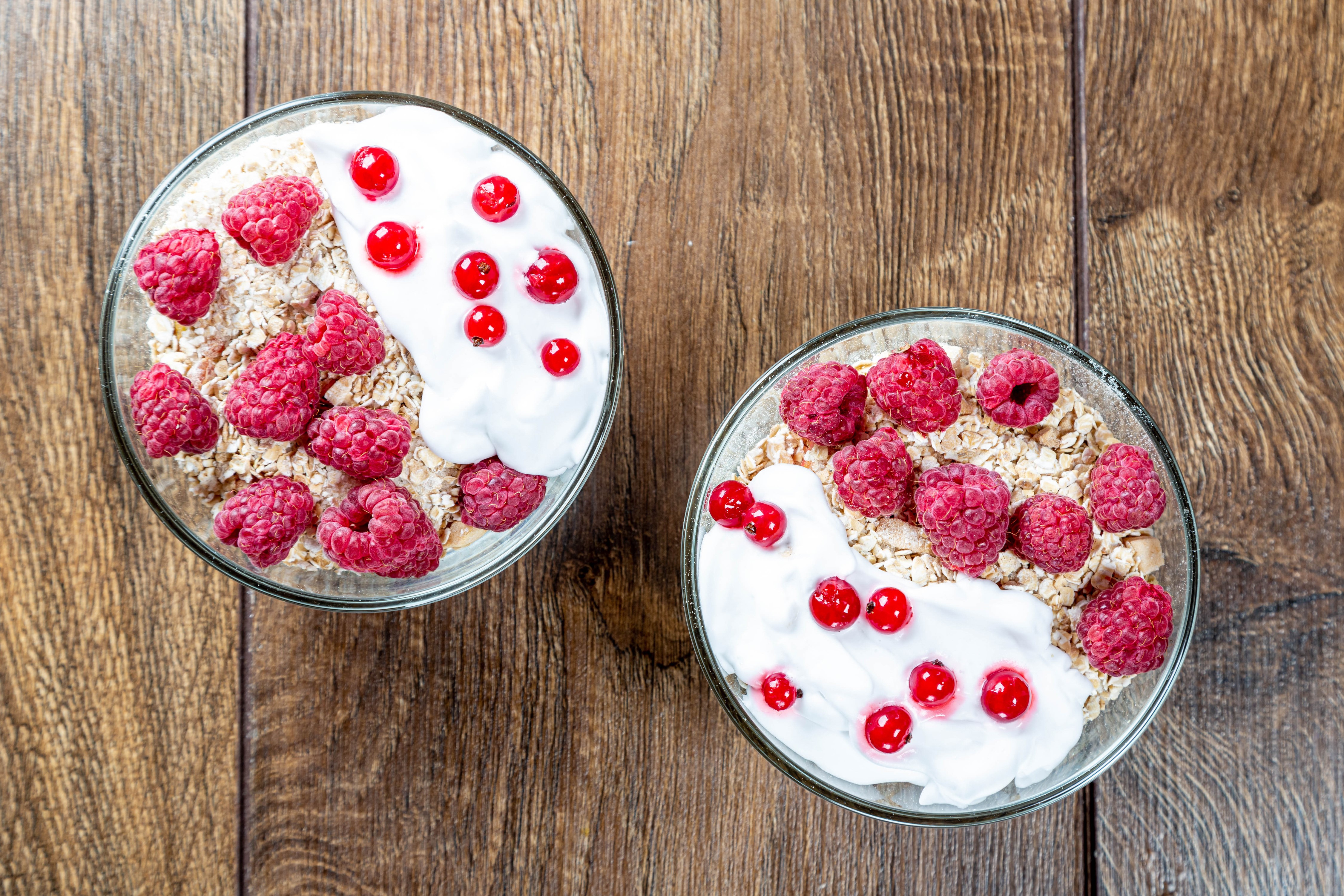 Muesli with raspberries and currants in bowls HD Wallpaper