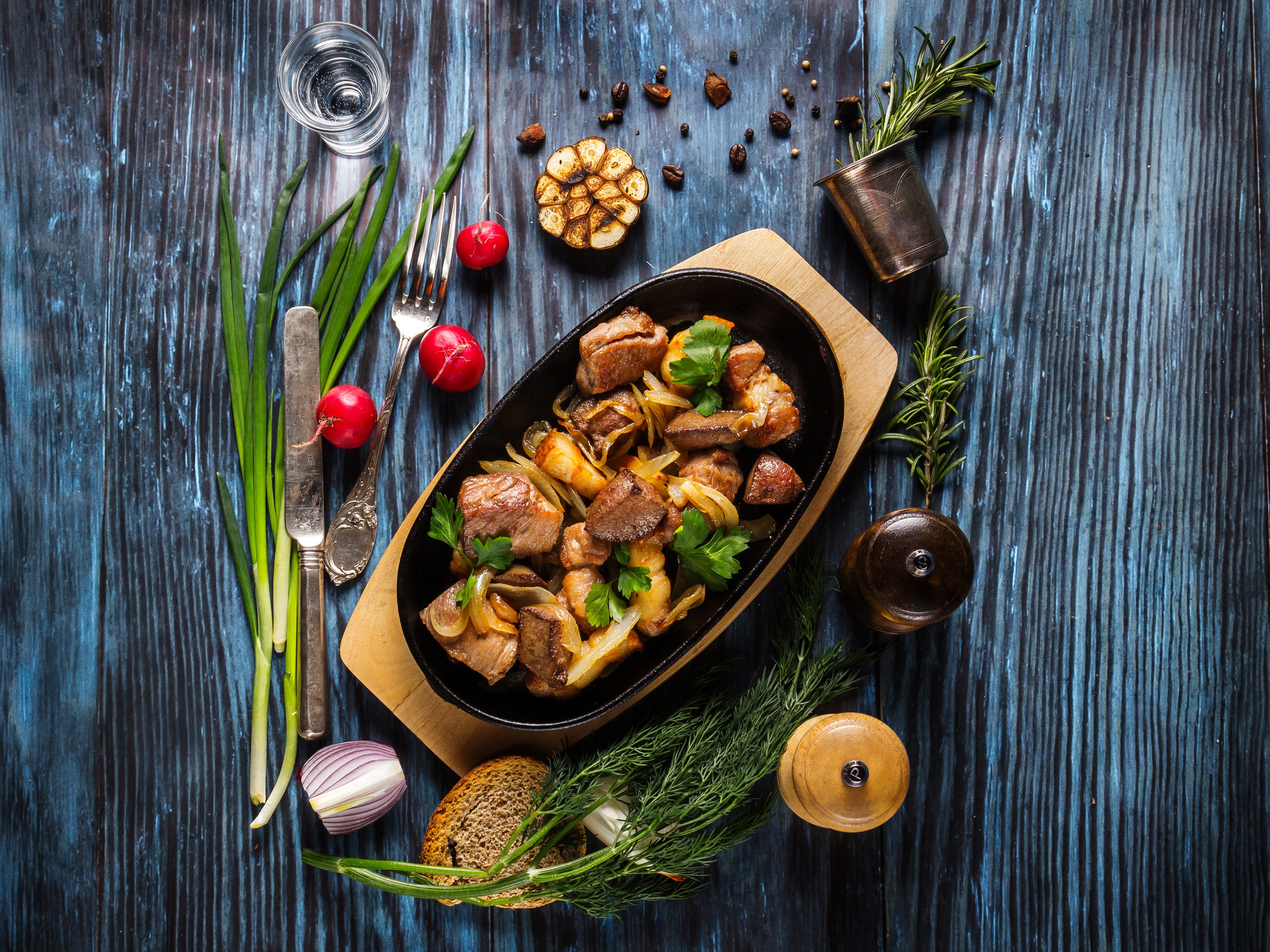 Meat dish with radishes, dill, and bread on wooden planks HD Wallpaper
