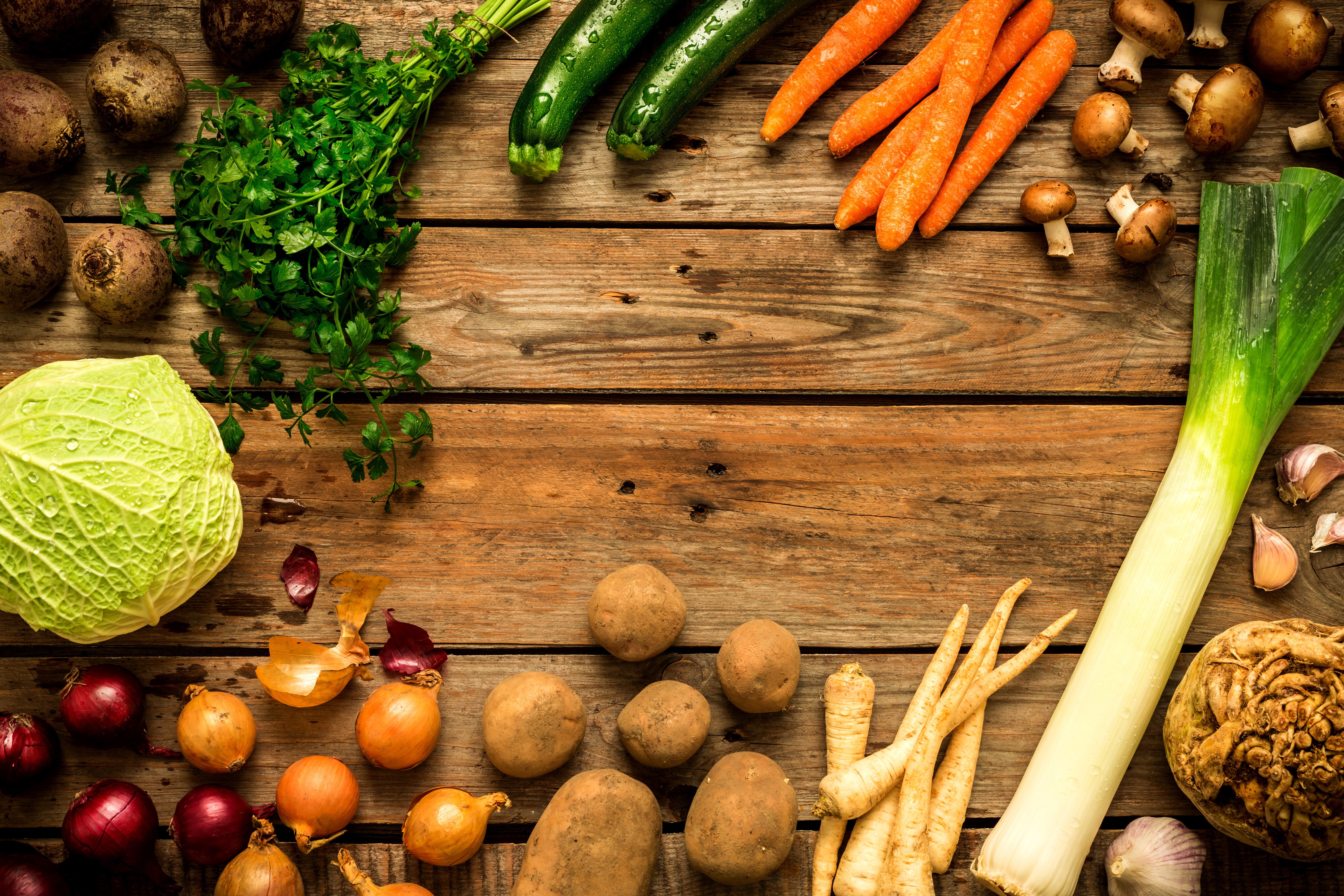 Assortment of fresh vegetables on wooden planks HD Wallpaper