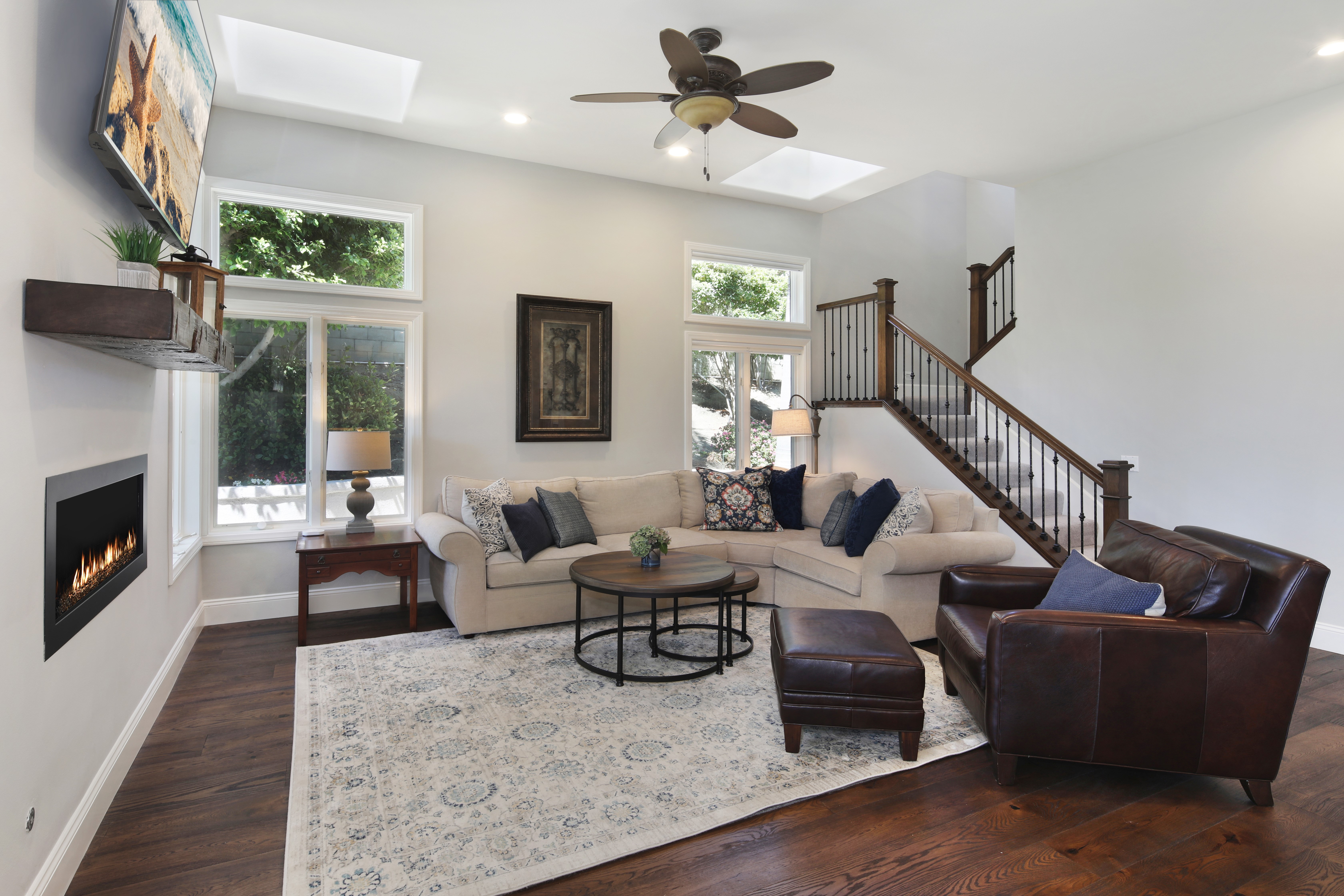 Living room with sofa, armchair, and fireplace HD Wallpaper