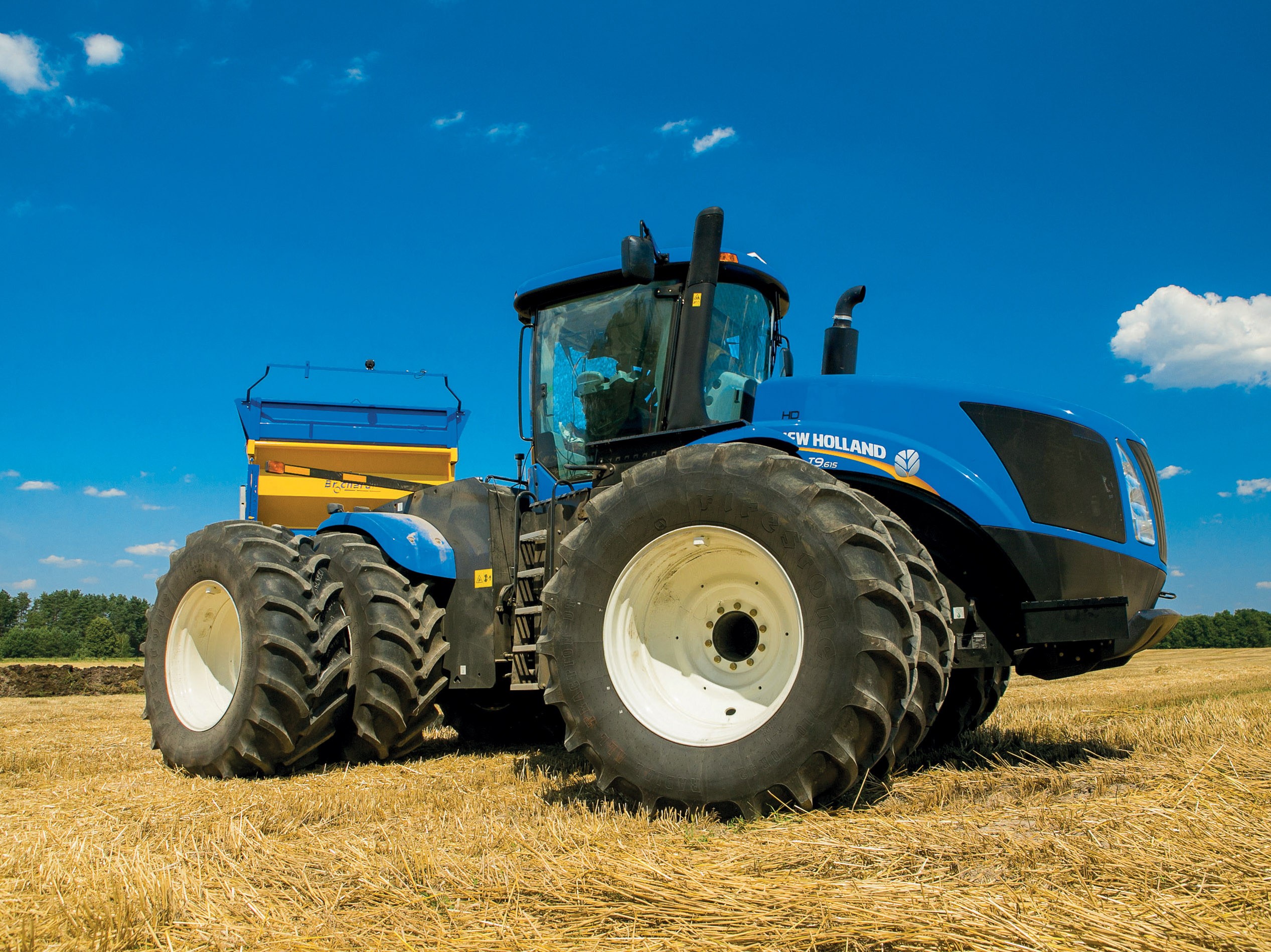 Blue New Holland T9.700 tractor with a seeder HD Wallpaper