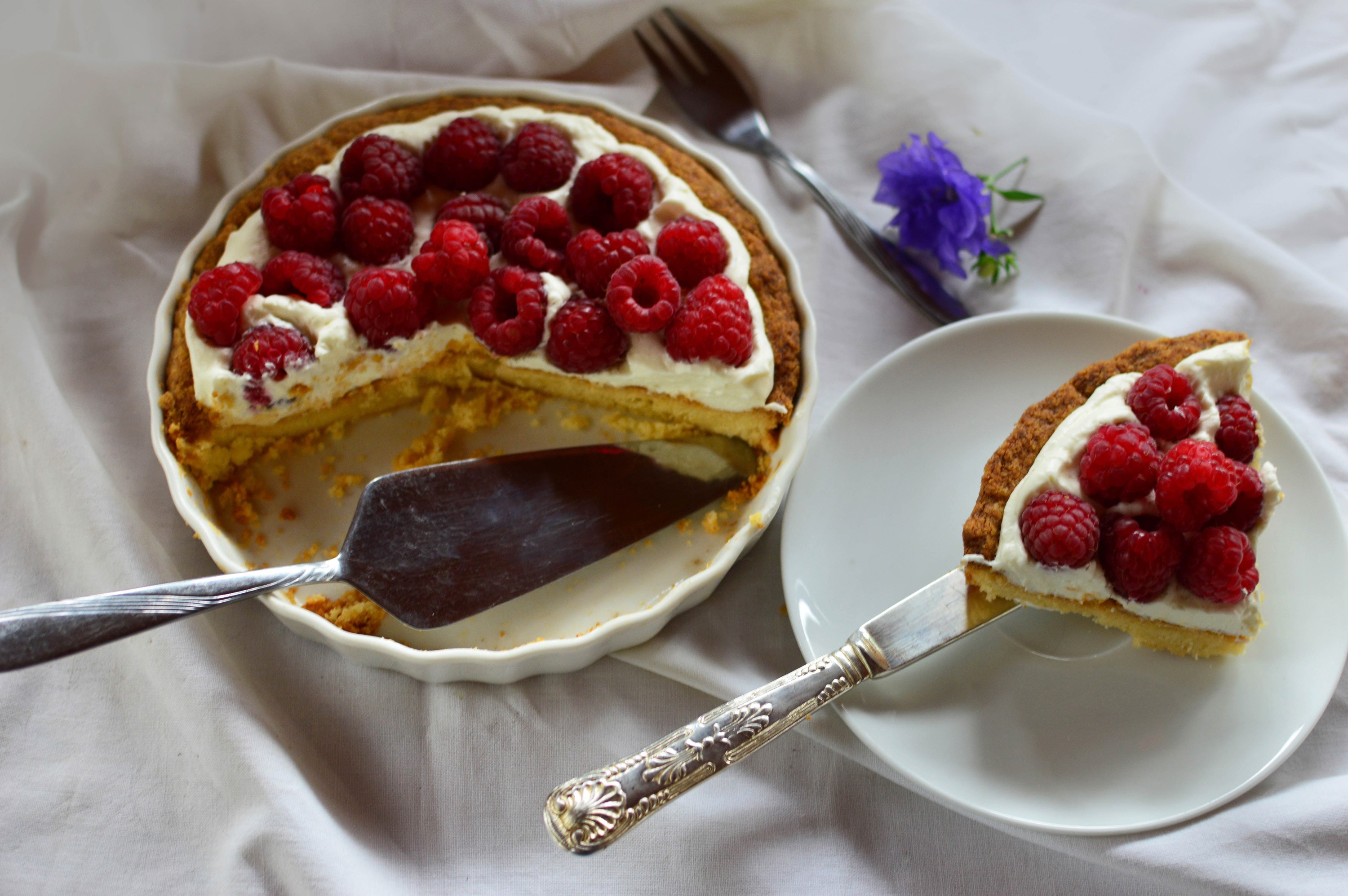 Raspberry pie with whipped cream and a slice on a plate HD Wallpaper