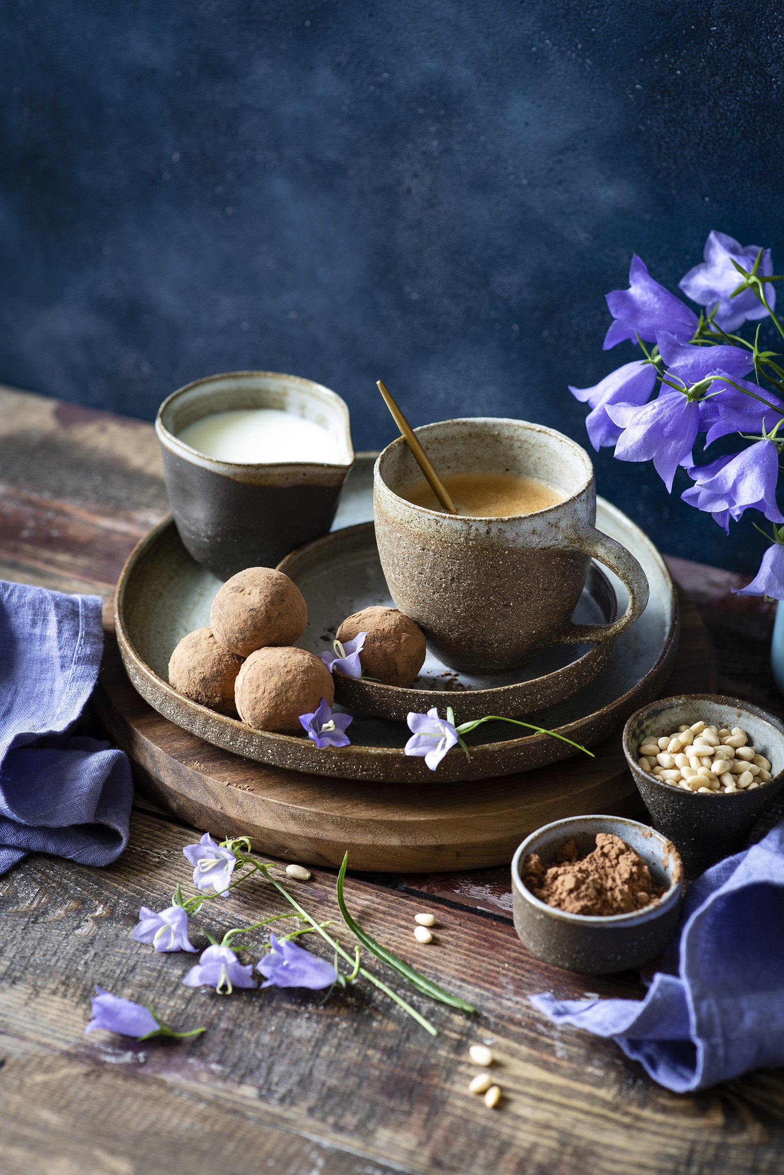 Coffee, truffles, milk, and flowers on a wooden table HD Phone Wallpaper