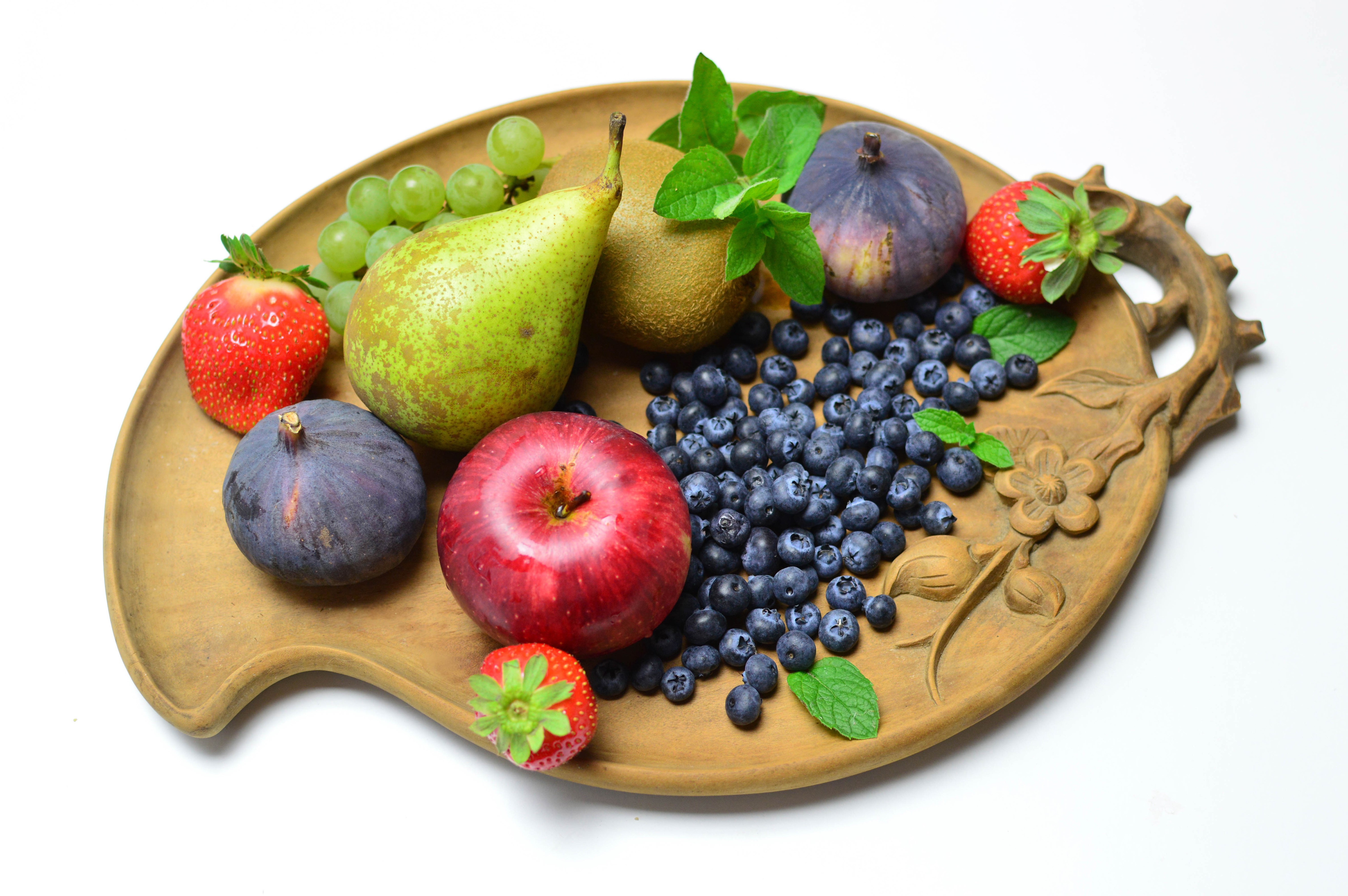 Assortment of Fresh Fruits on a Wooden Platter HD Wallpaper