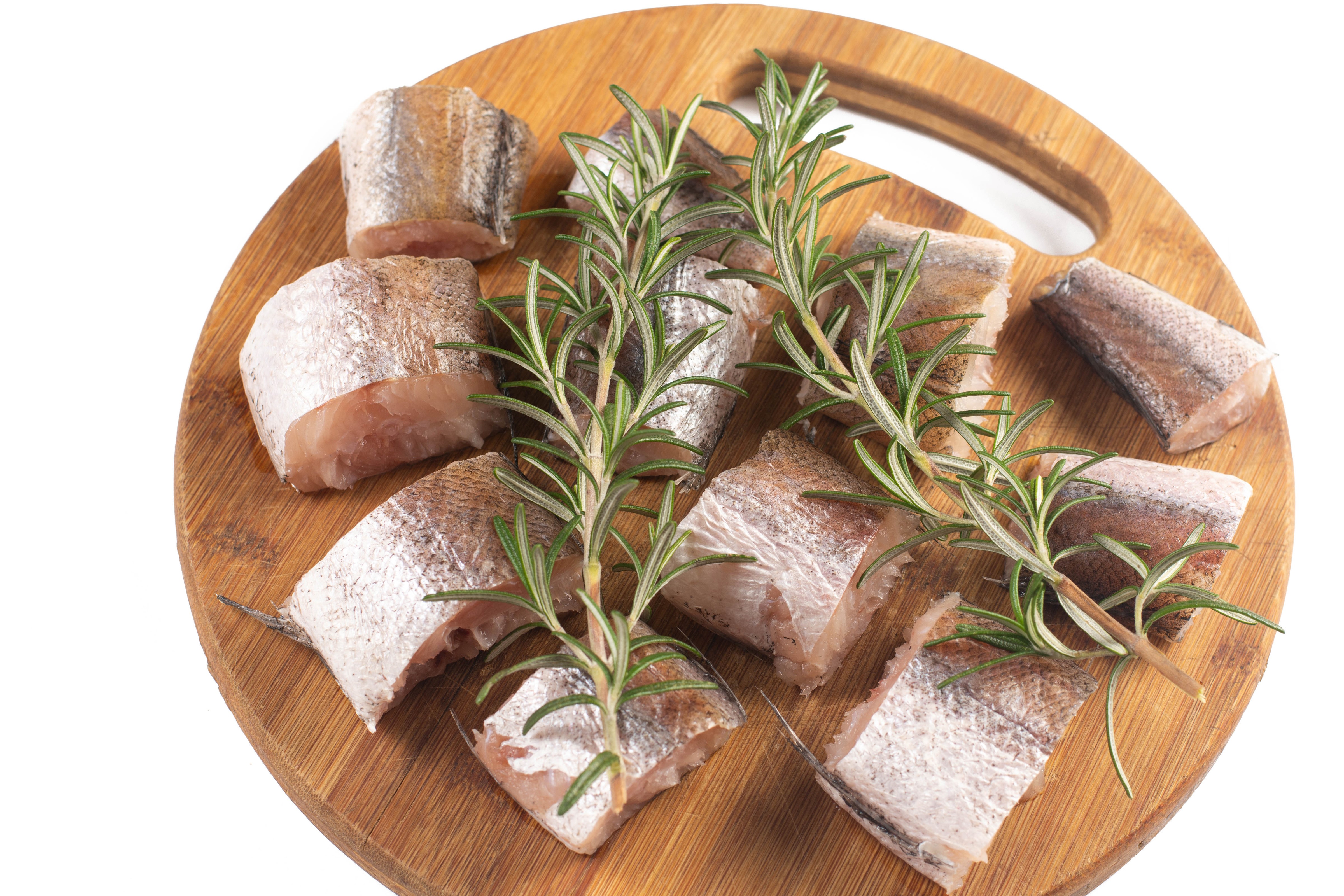 Fish pieces with rosemary on a cutting board HD Wallpaper