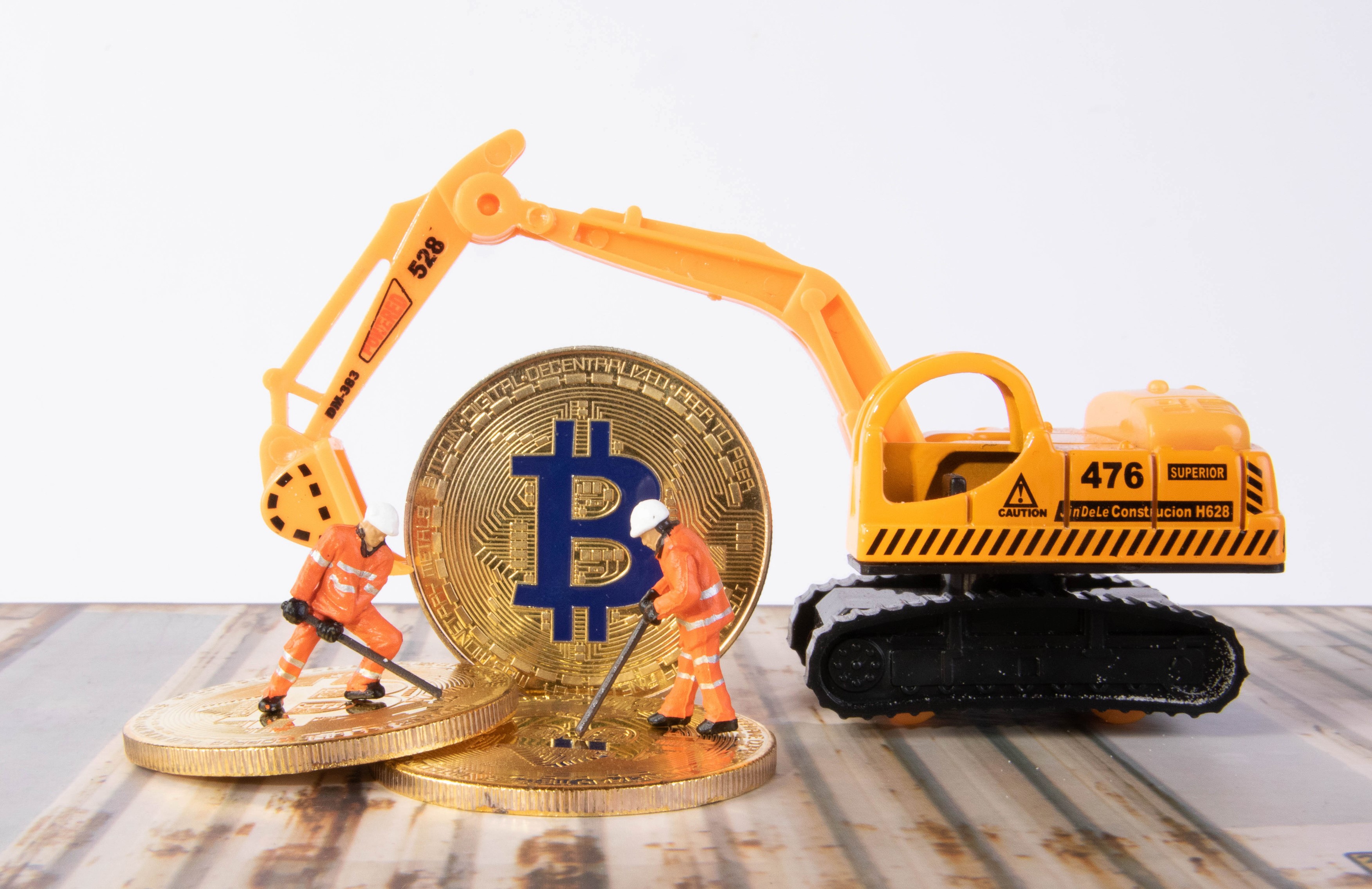 Toy excavator and Bitcoin mining figures HD Wallpaper