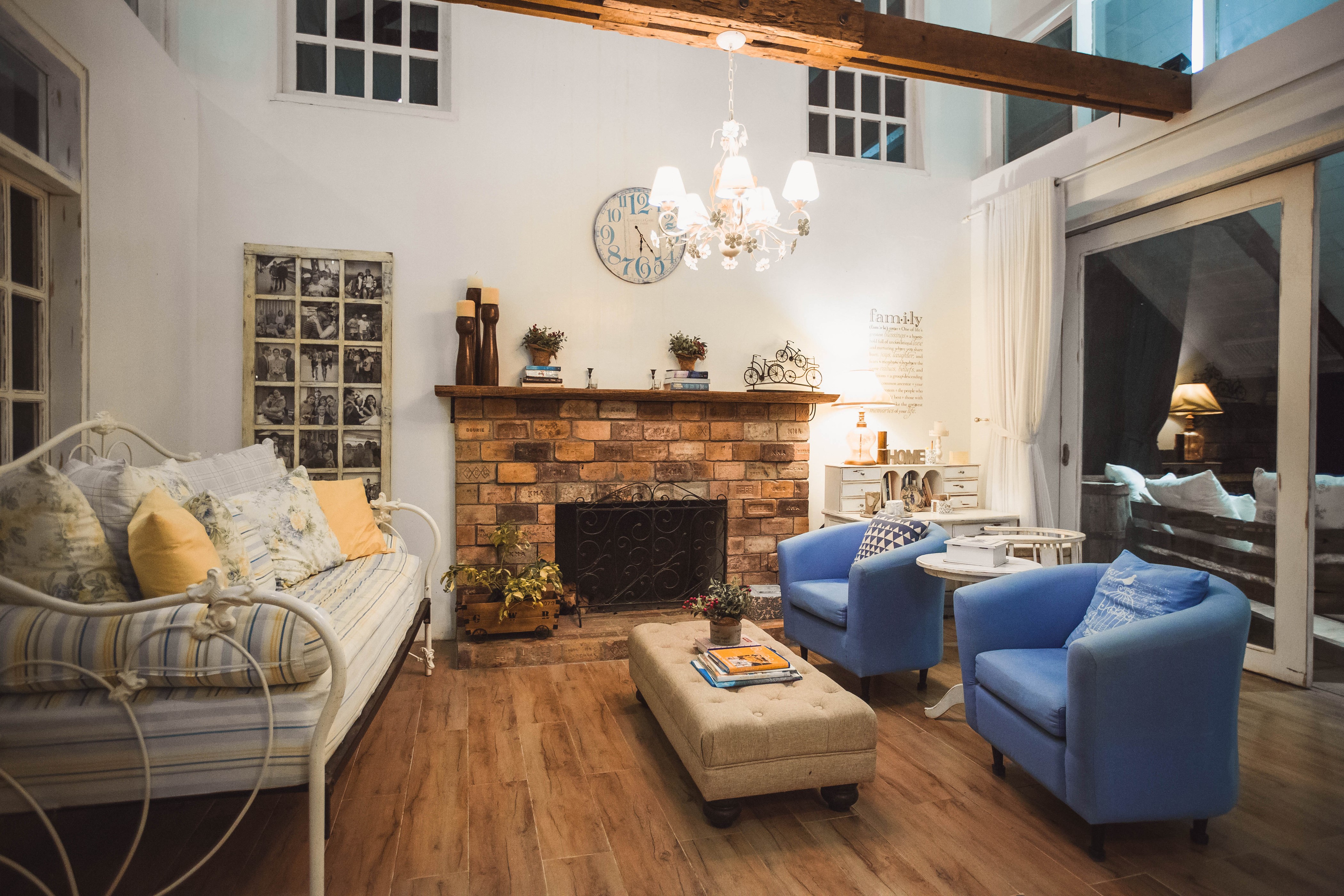 Living room with fireplace, sofa, and armchairs HD Wallpaper
