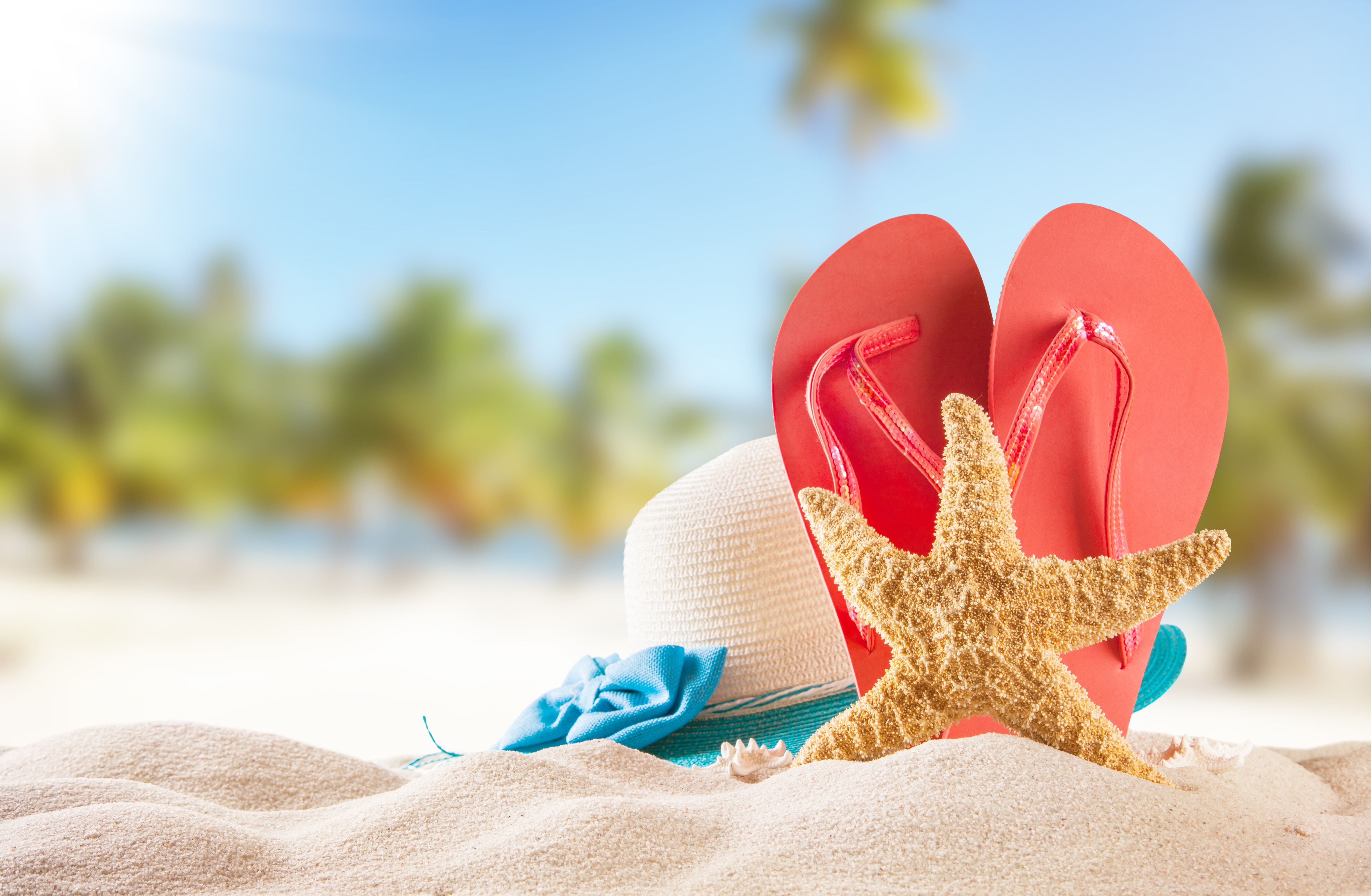 Summer beach scene with starfish, flip-flops, and hat HD Wallpaper