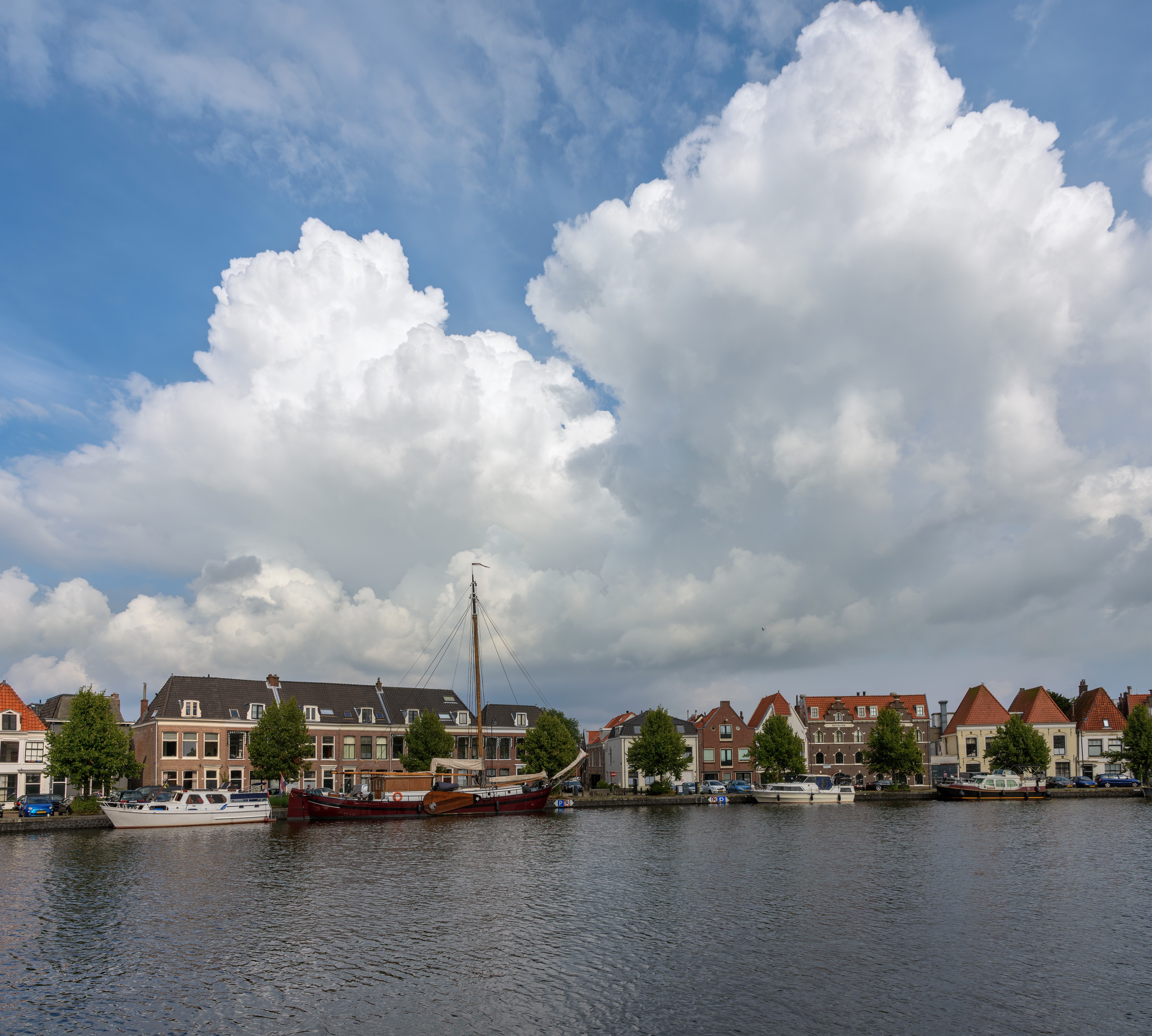 Houses and boats on a canal in Haarlem, Netherlands HD Wallpaper