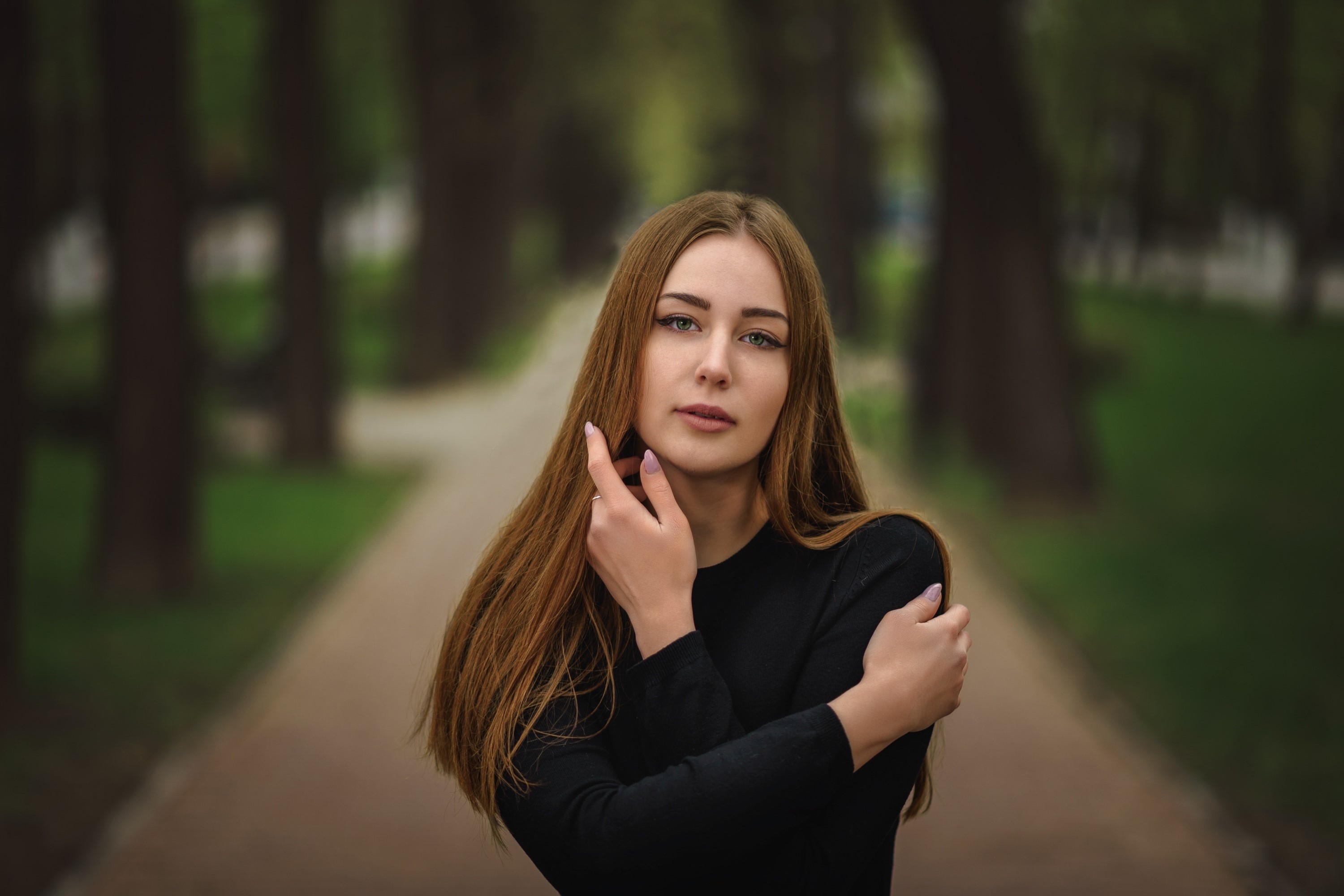 Brown-haired woman with hands near face in park HD Wallpaper