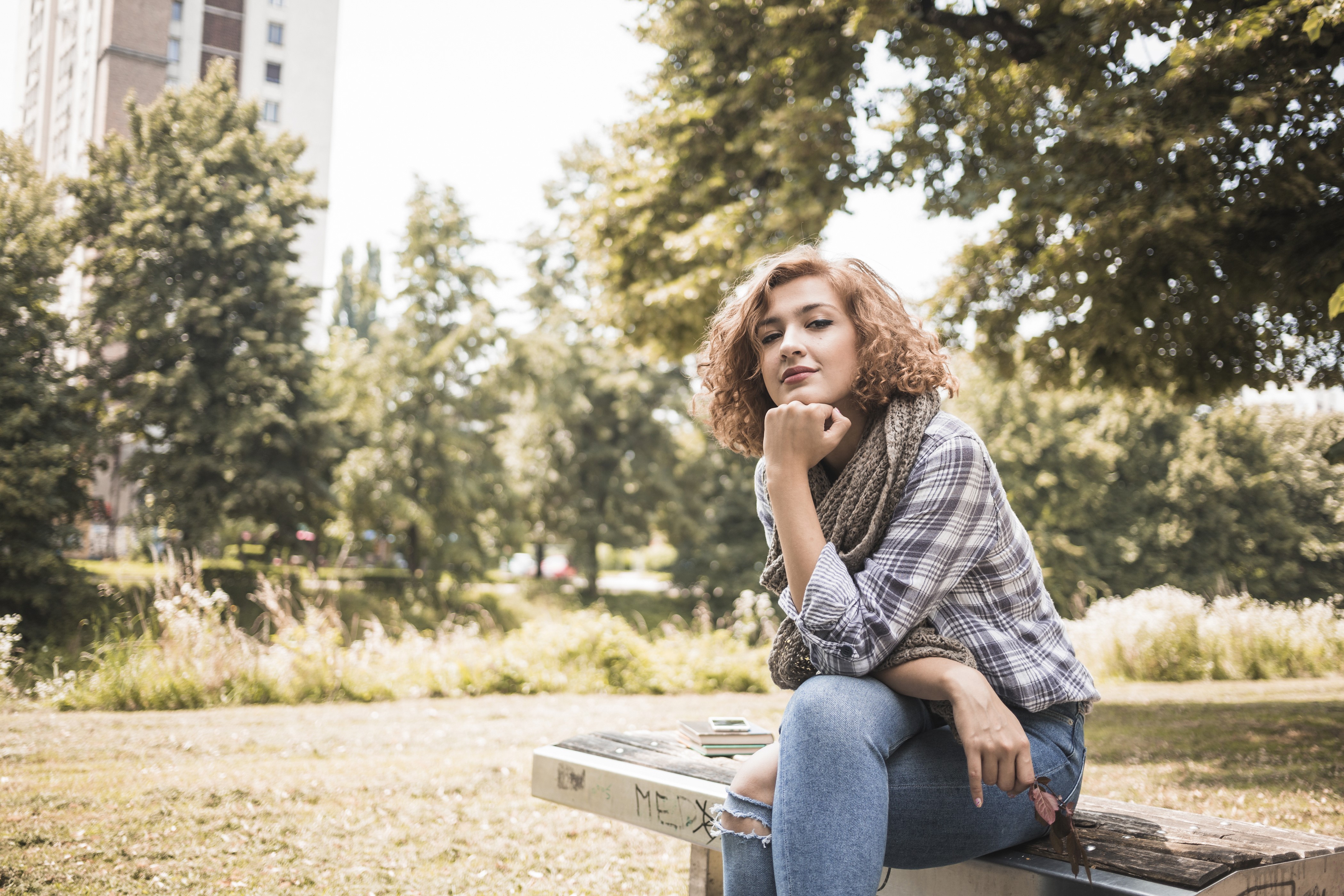 Woman Sitting on a Bench in a Park HD Wallpaper