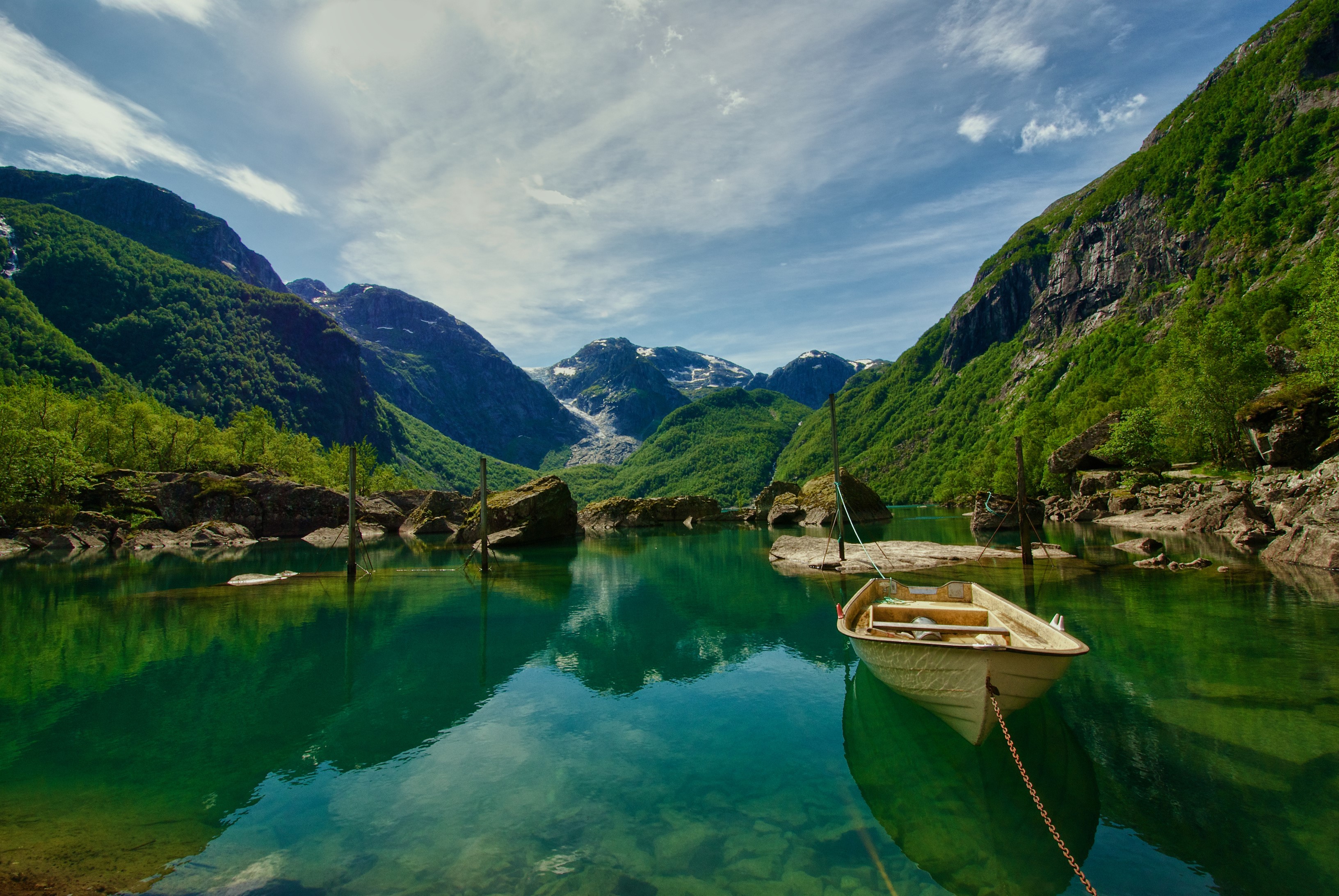 Boat on Bondhusvatnet lake in Norway with mountains HD Wallpaper