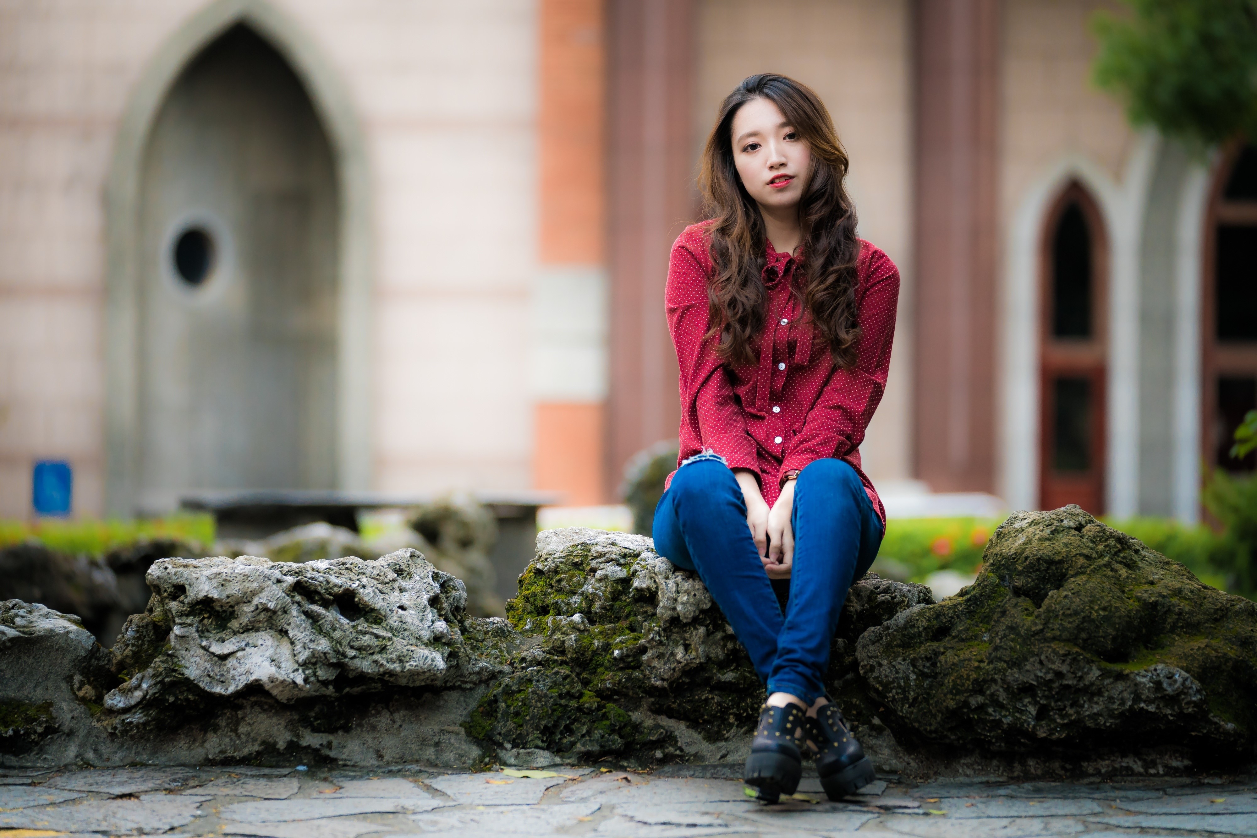 Asian woman sitting on stones with bokeh background HD Wallpaper