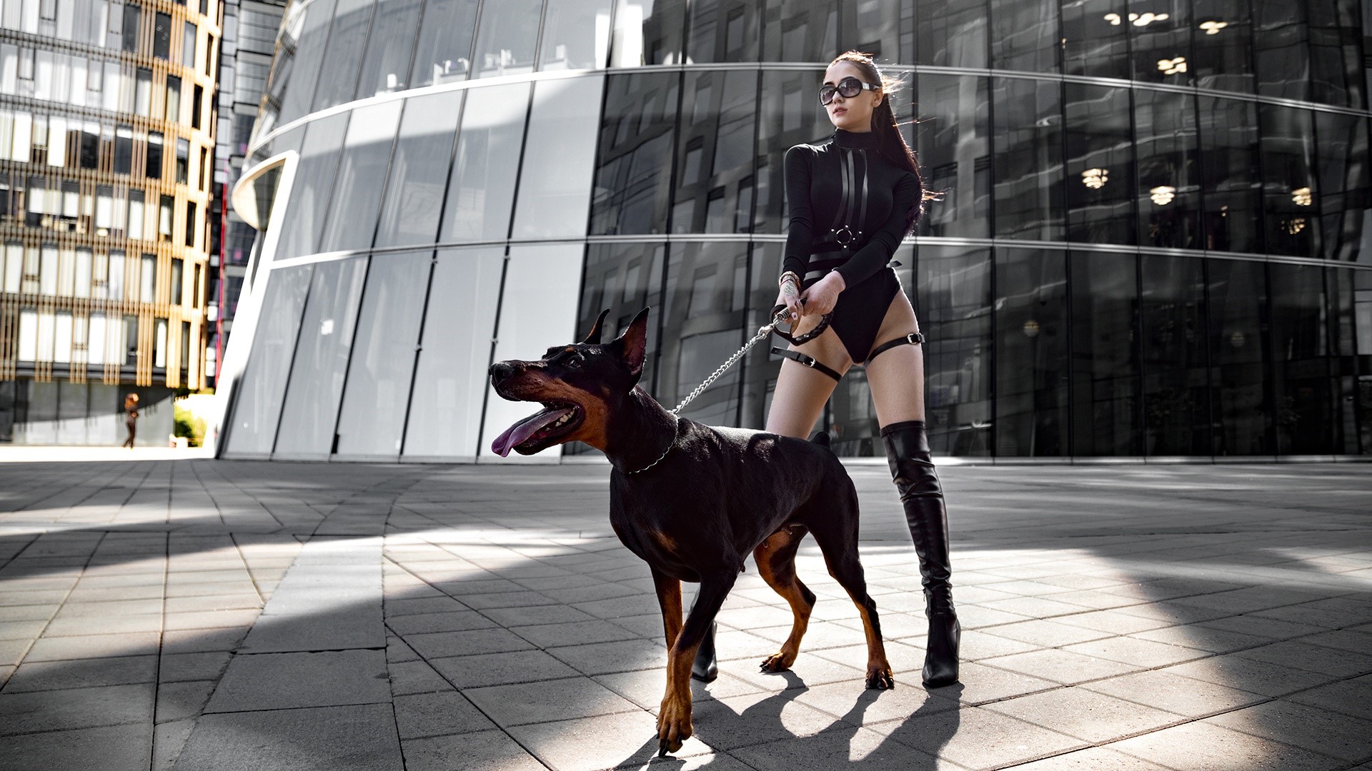 Woman in black bodysuit with Doberman Pinscher HD Wallpaper