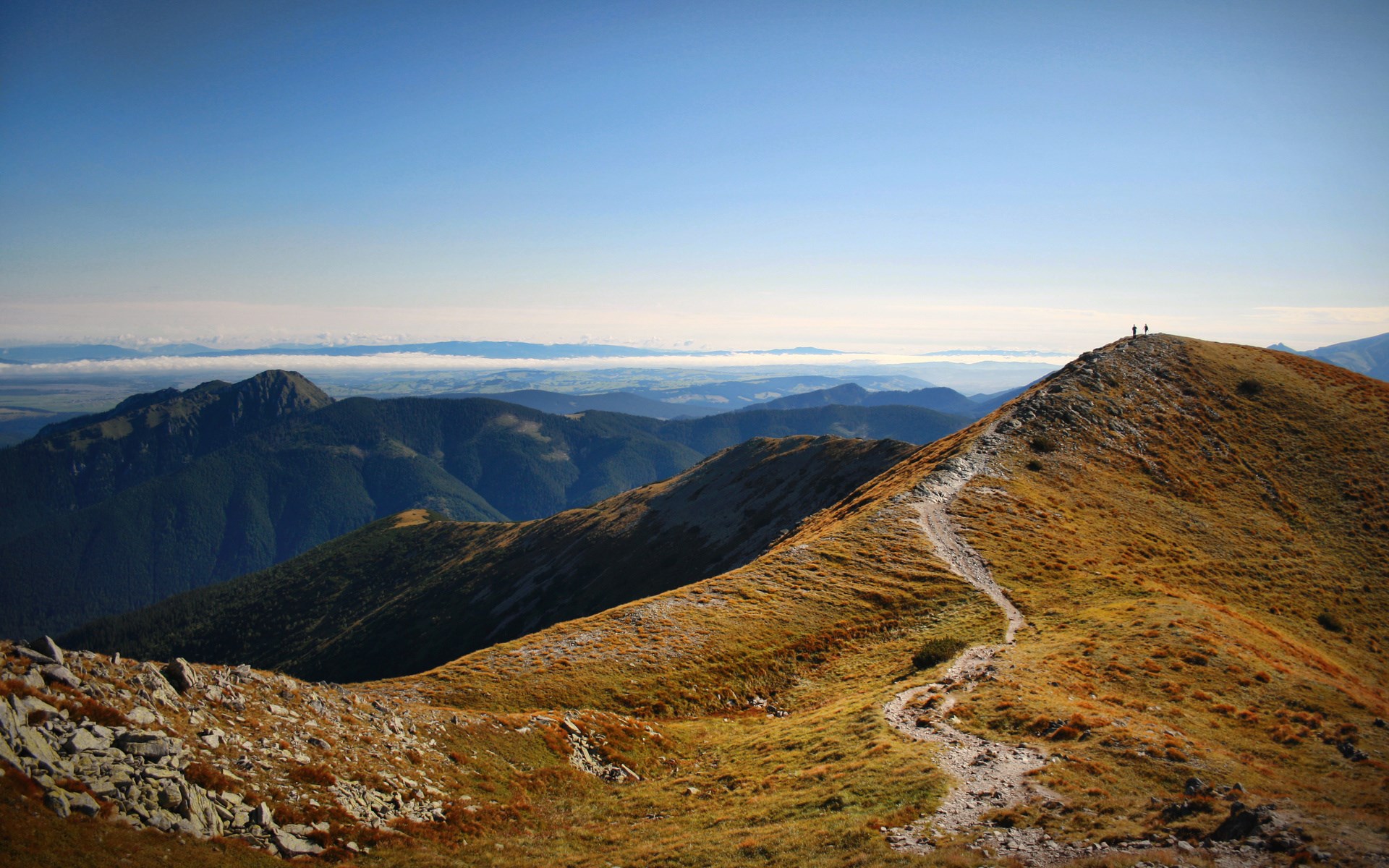 Mountain ridge with hikers and distant landscape HD Wallpaper