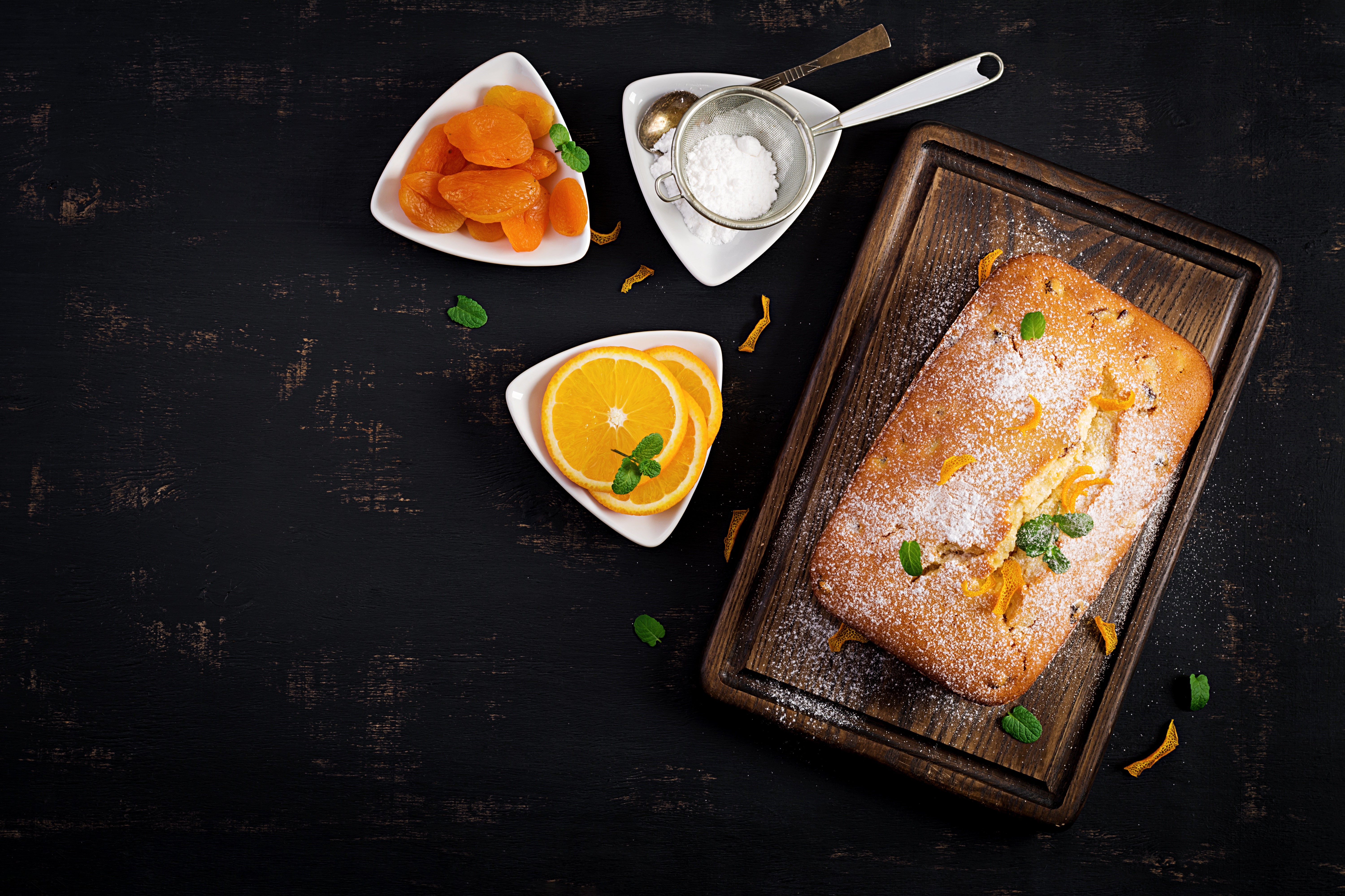 Orange cake with dried apricots and powdered sugar HD Wallpaper