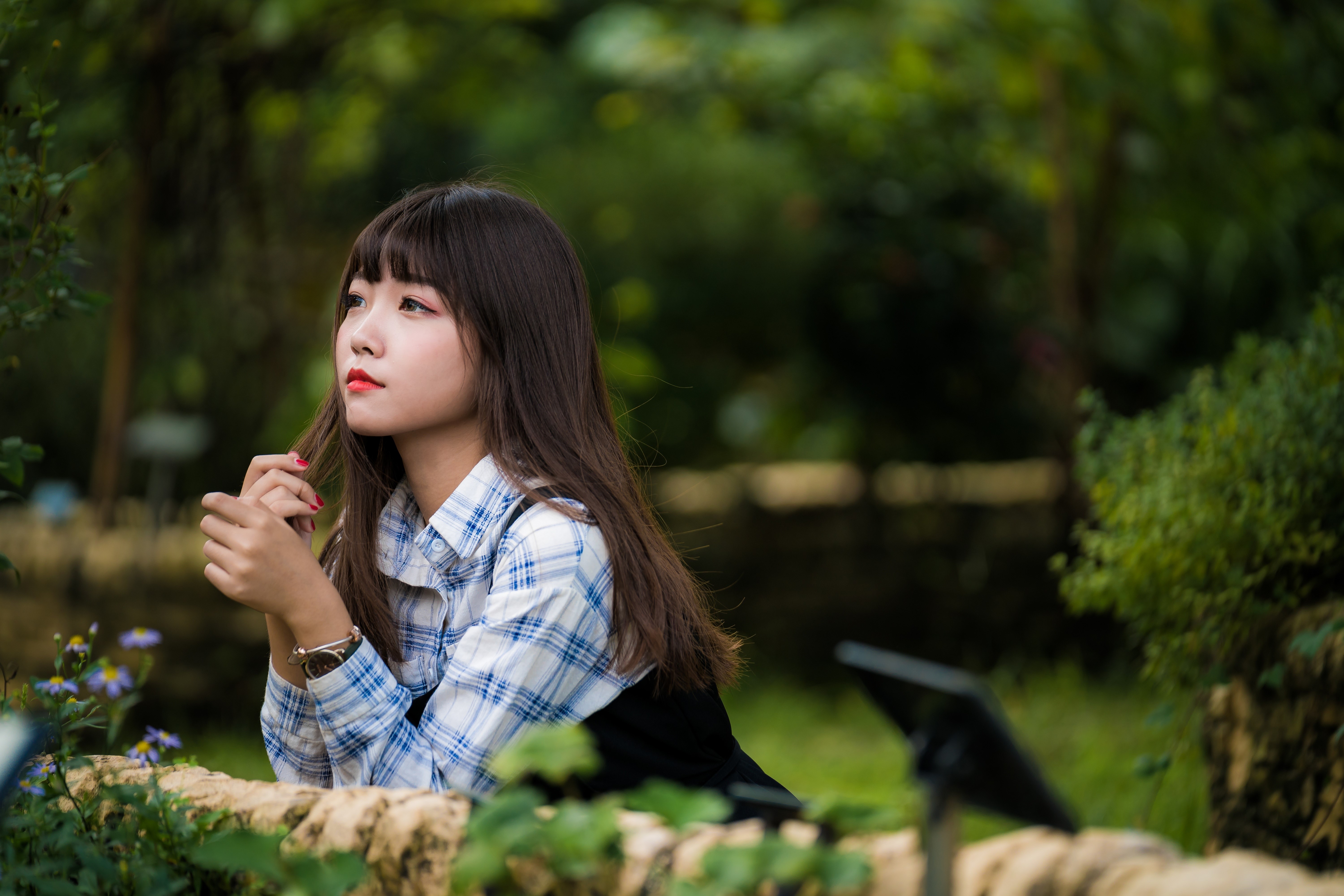 Brunette girl in plaid shirt in garden HD Wallpaper