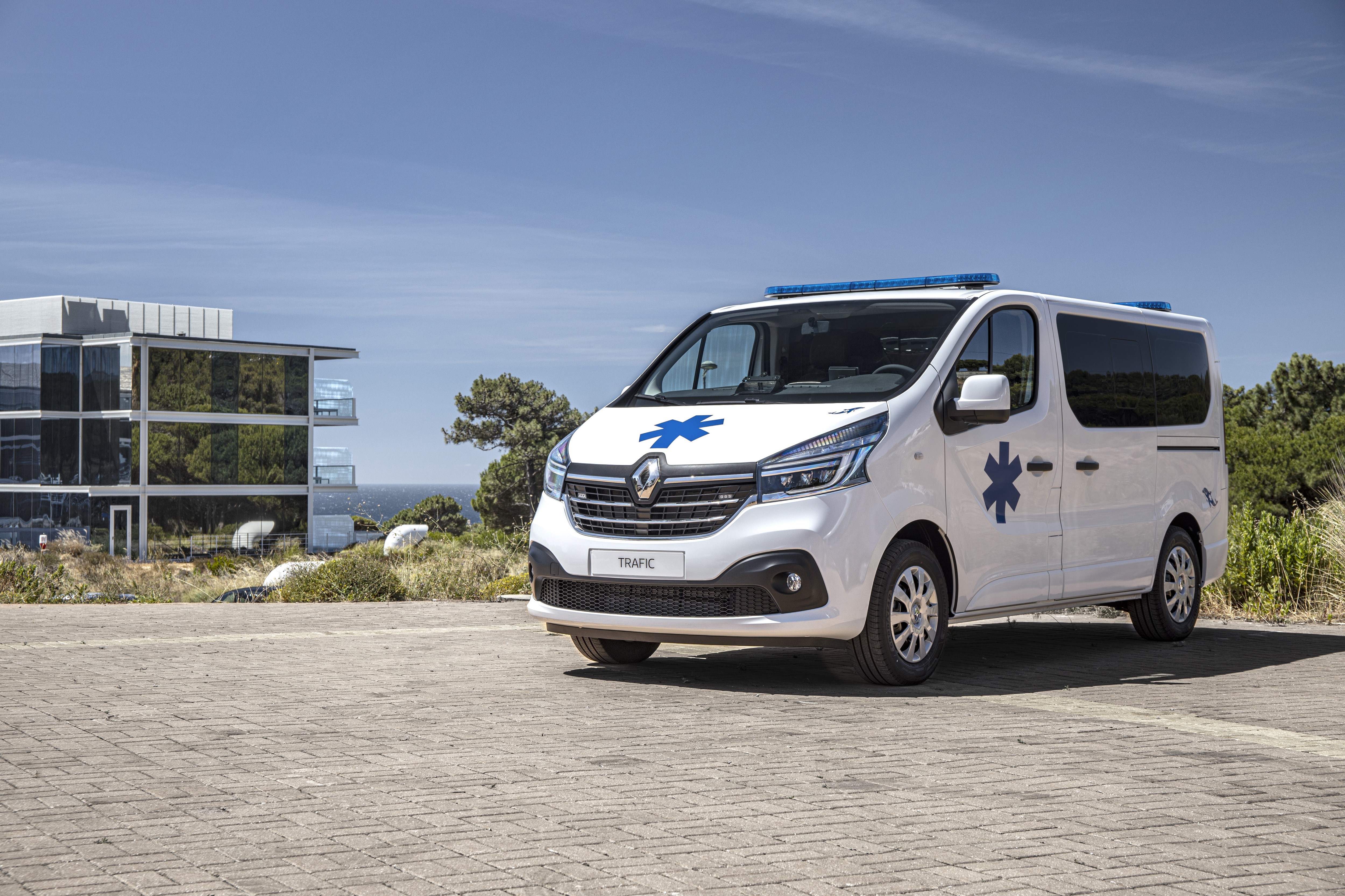White Renault Trafic Ambulance with Blue Lights HD Wallpaper