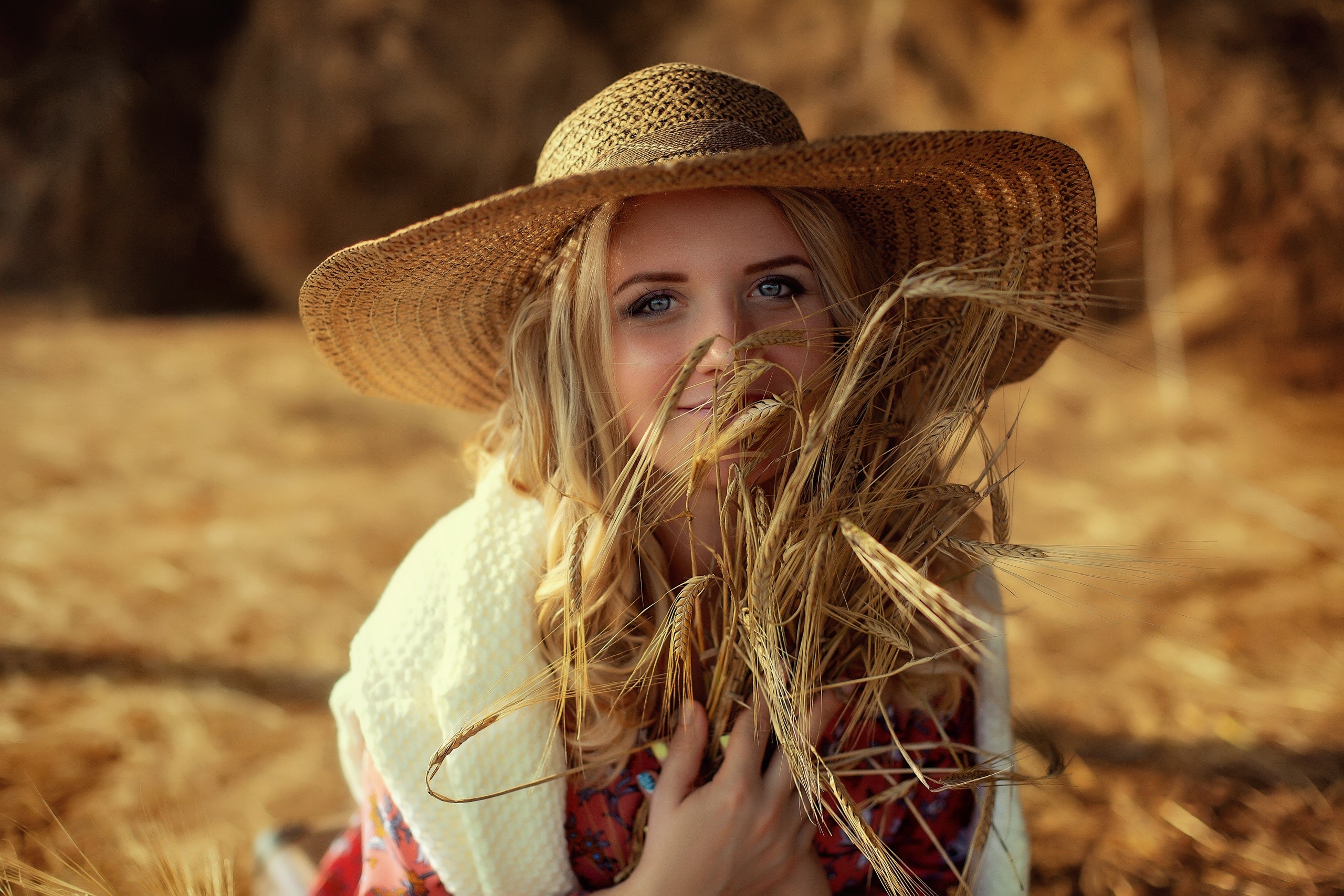Woman in straw hat with wheat in a field HD Wallpaper