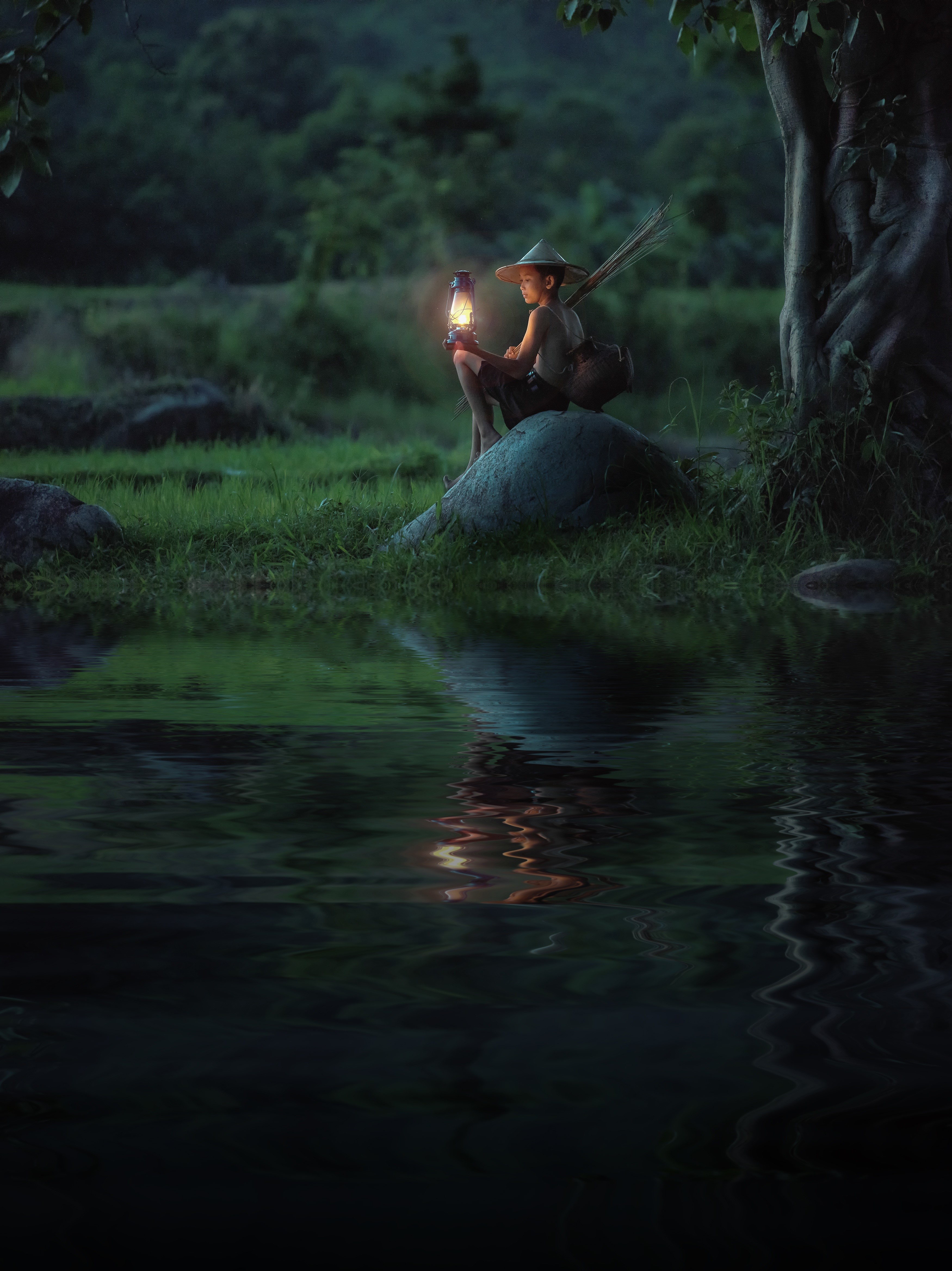 Boy with kerosene lamp sitting on a stone at night HD Phone Wallpaper