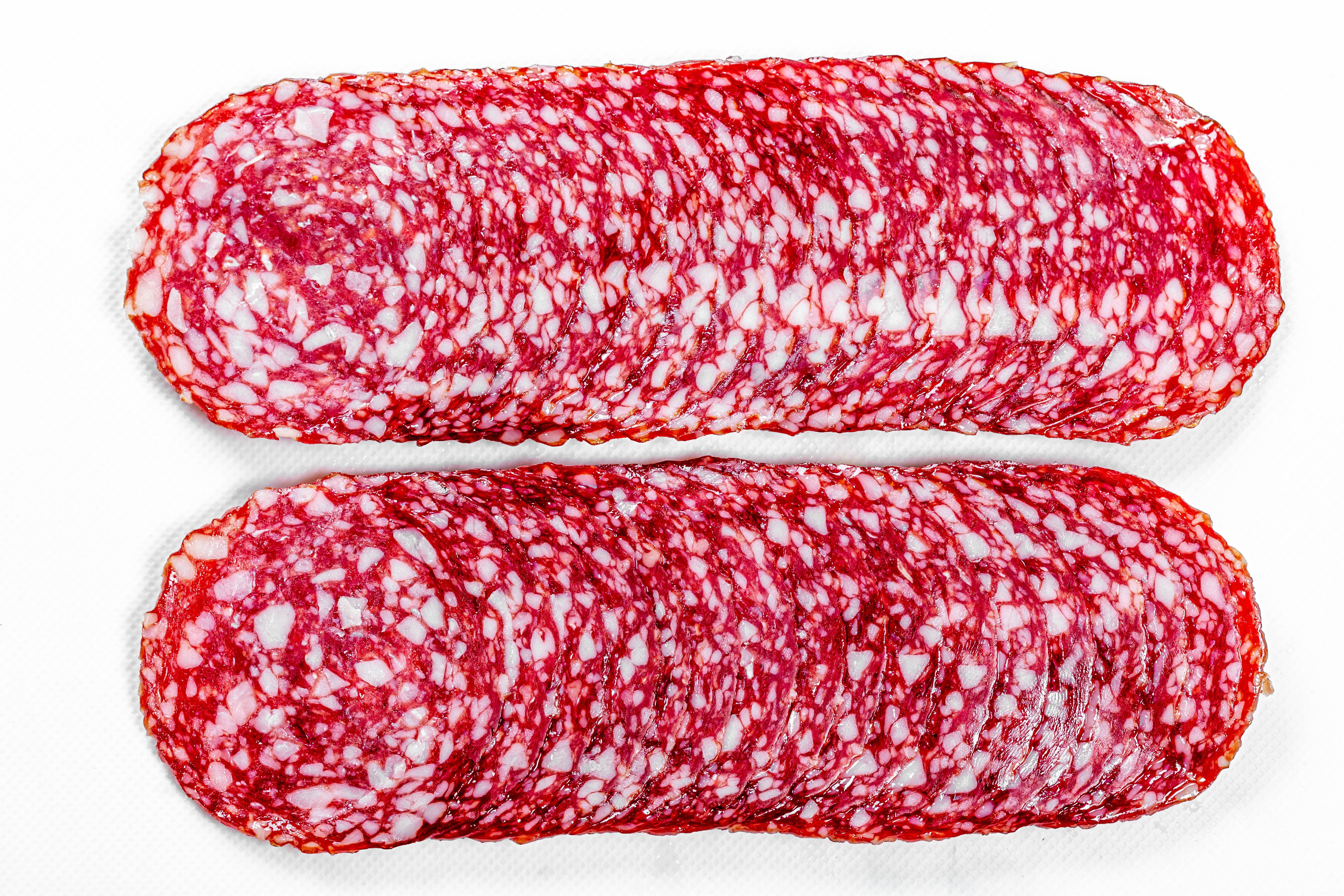 Sliced Salami Sausage on White Background HD Wallpaper