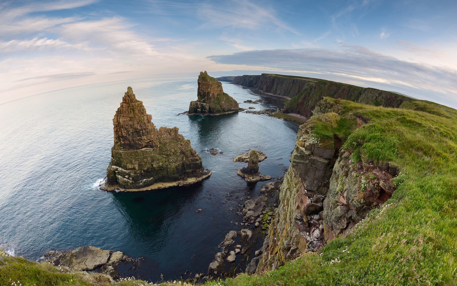 Sea stacks and cliffs along a coastline HD Wallpaper