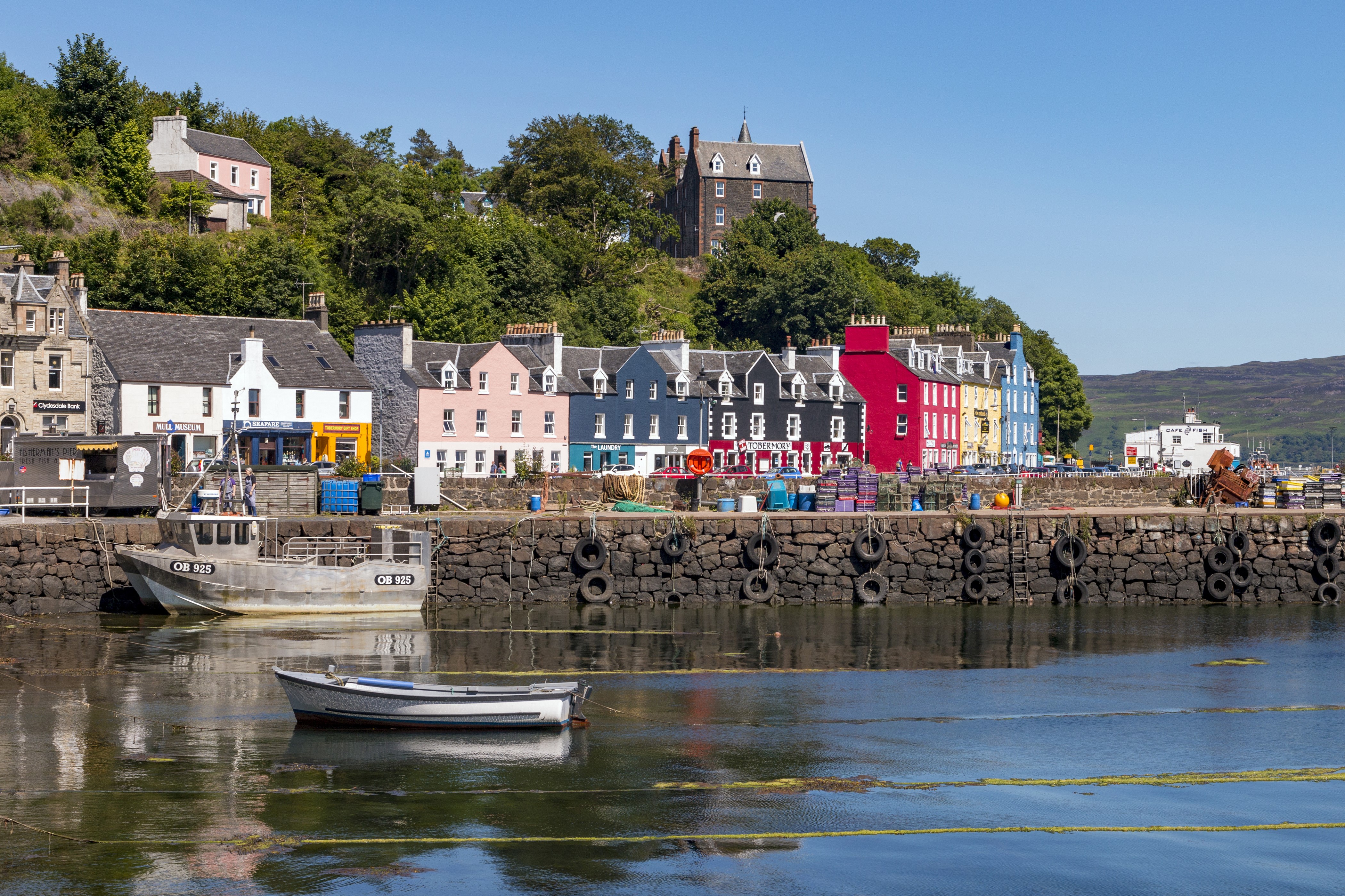 Colorful houses on a hill overlooking a harbor with boats HD Wallpaper