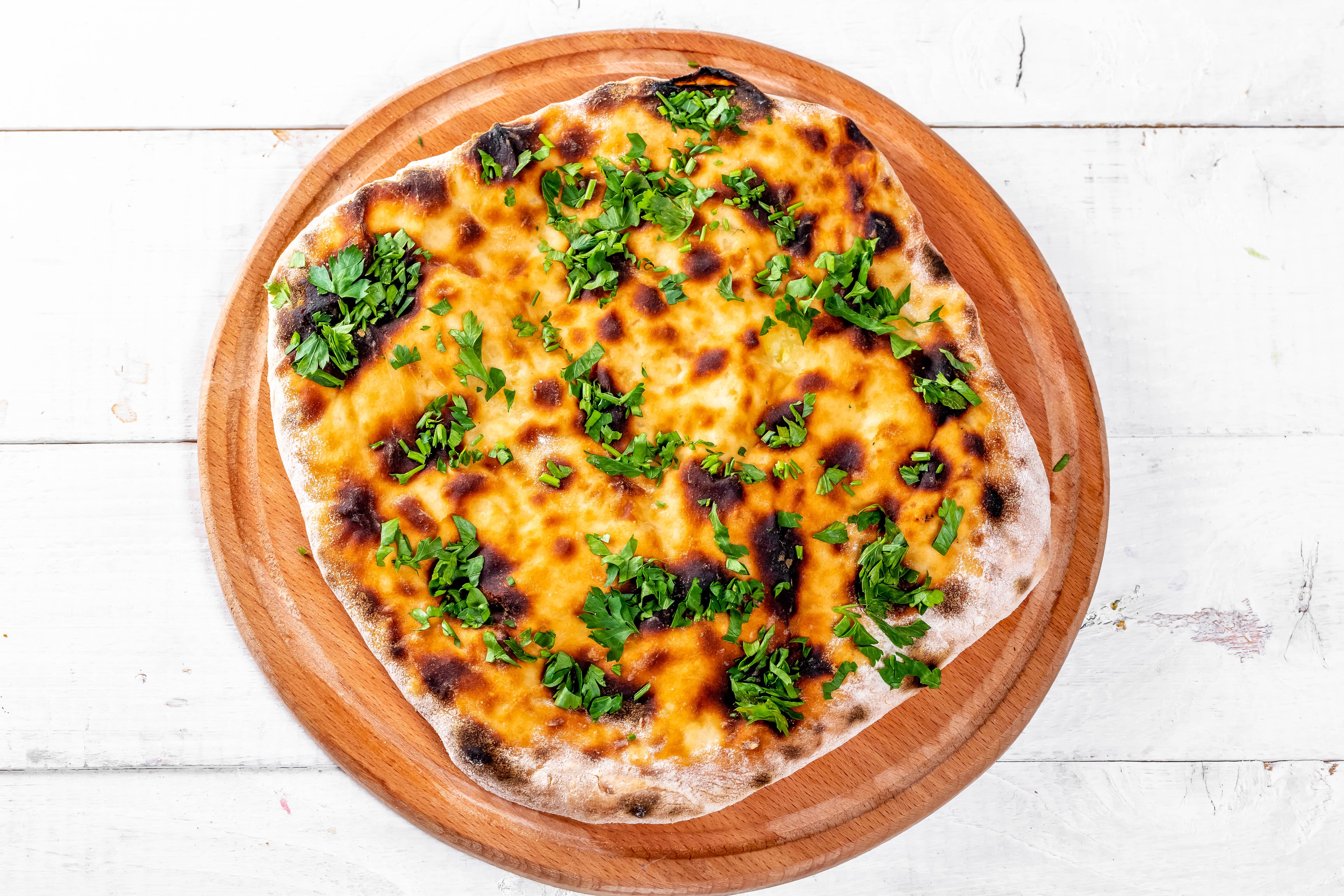 Khachapuri on a wooden cutting board HD Wallpaper
