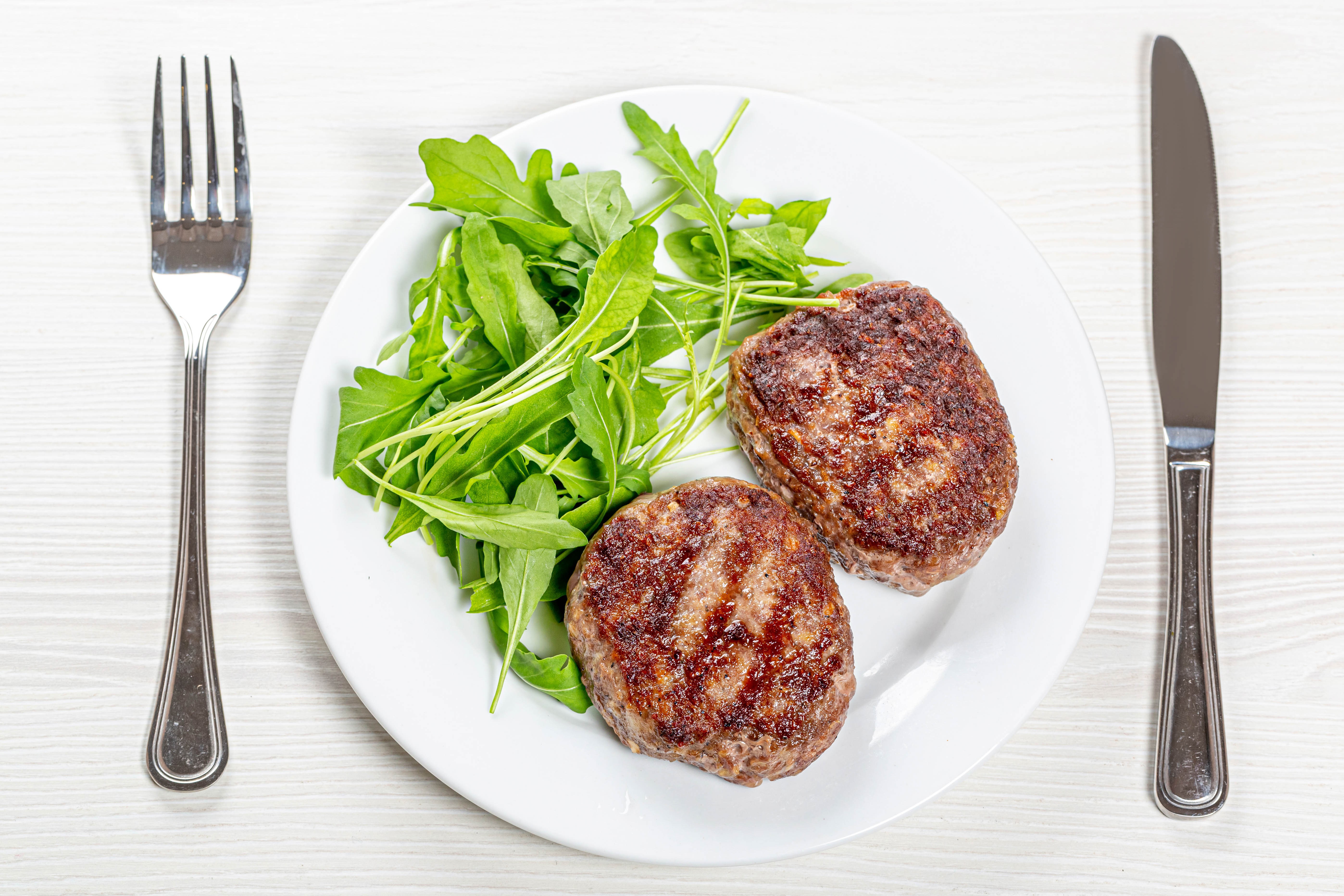 Two Frikadeller with Arugula Salad on a Plate HD Wallpaper