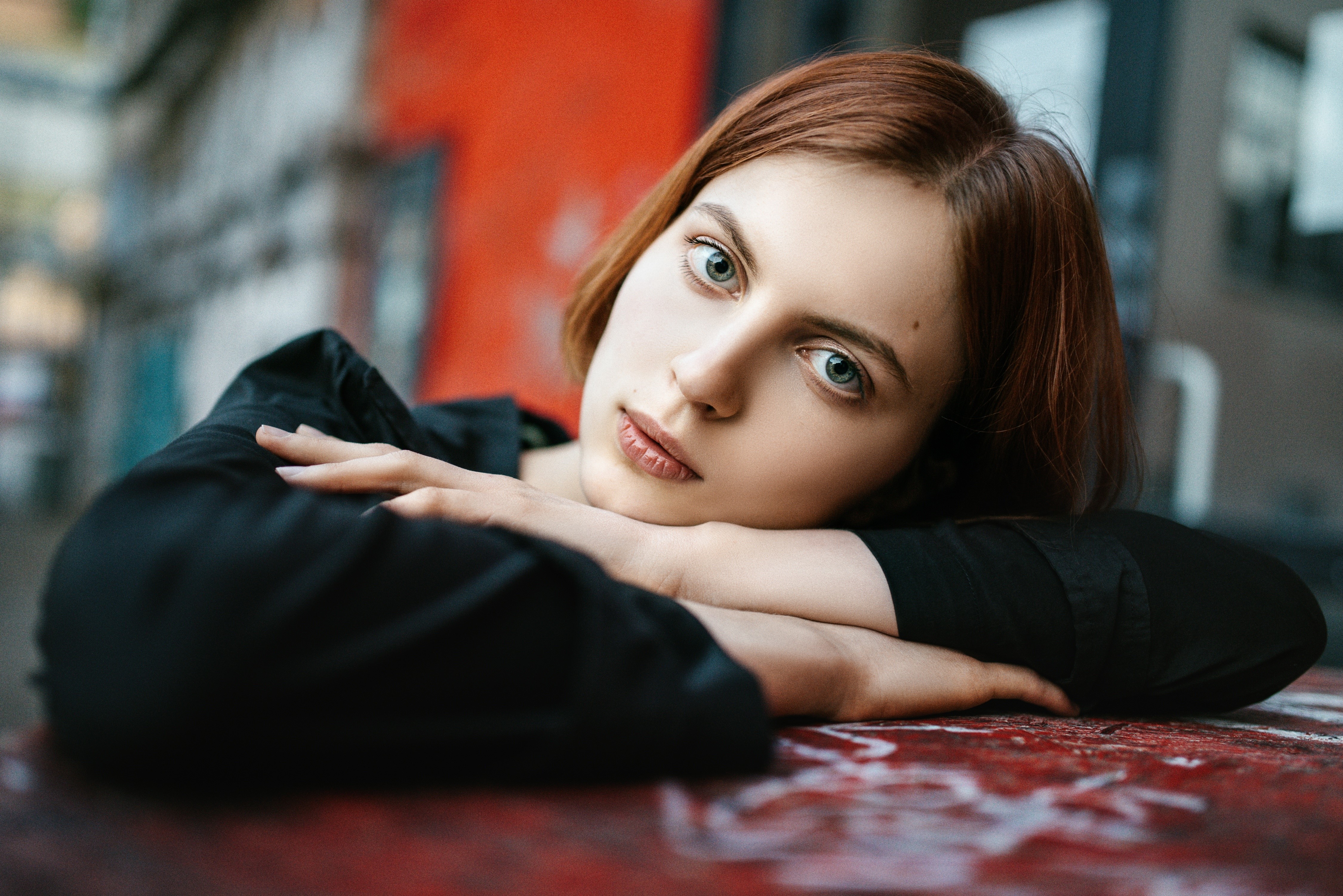 Brown haired woman resting her head on her hands HD Wallpaper