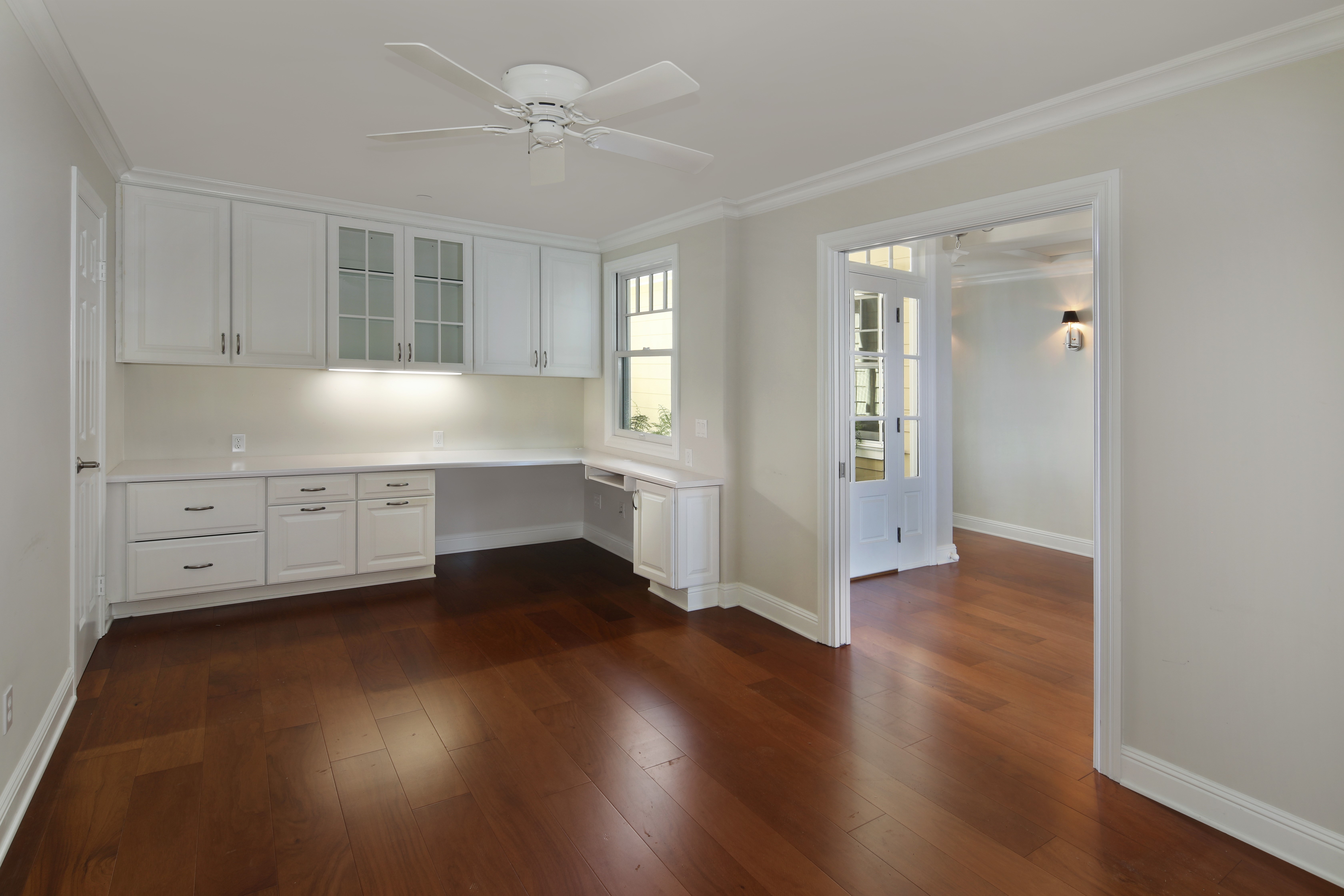Interior design of a home office with built-in cabinets and desk HD Wallpaper