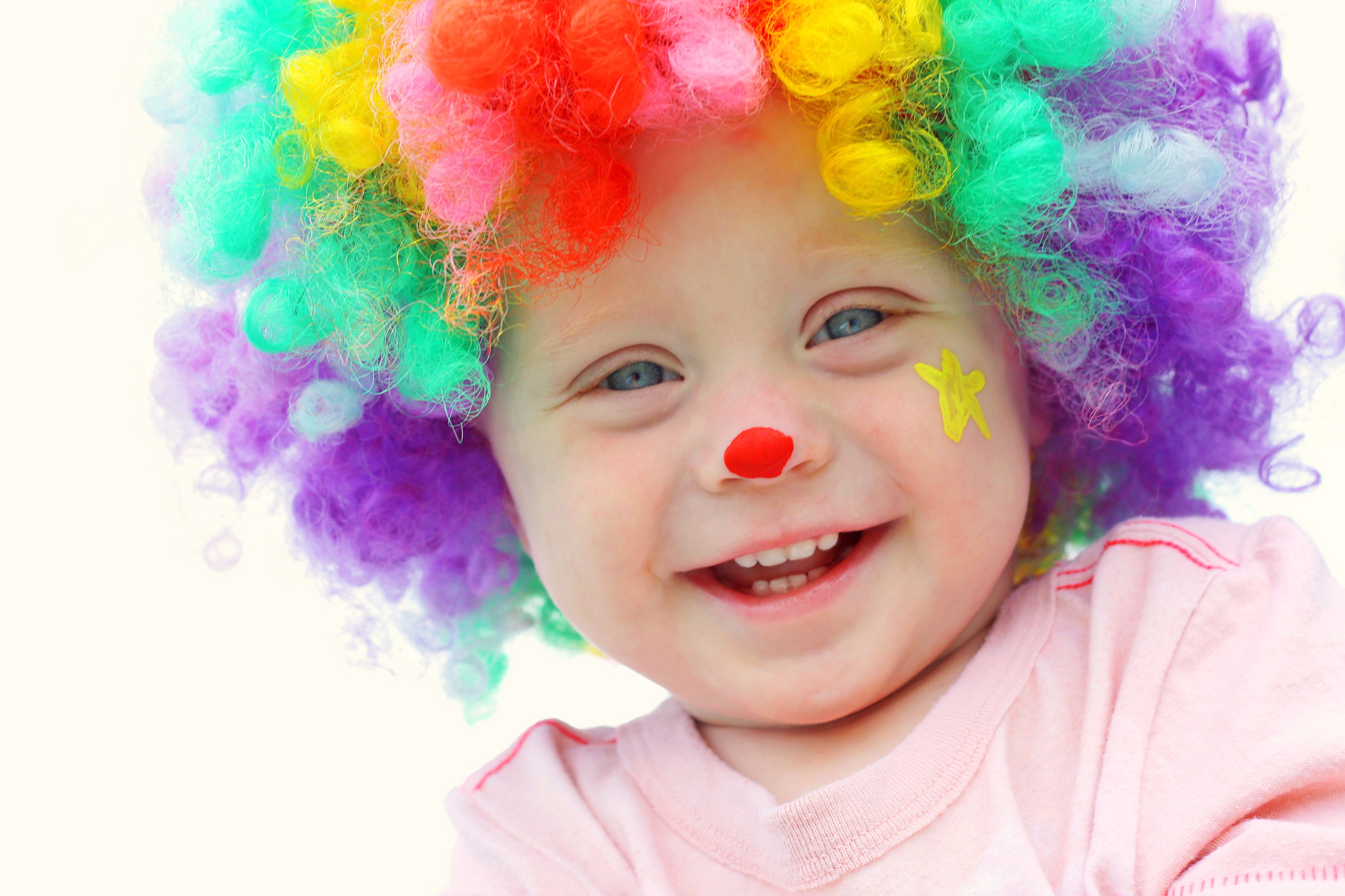 Child dressed as a clown with colorful wig HD Wallpaper