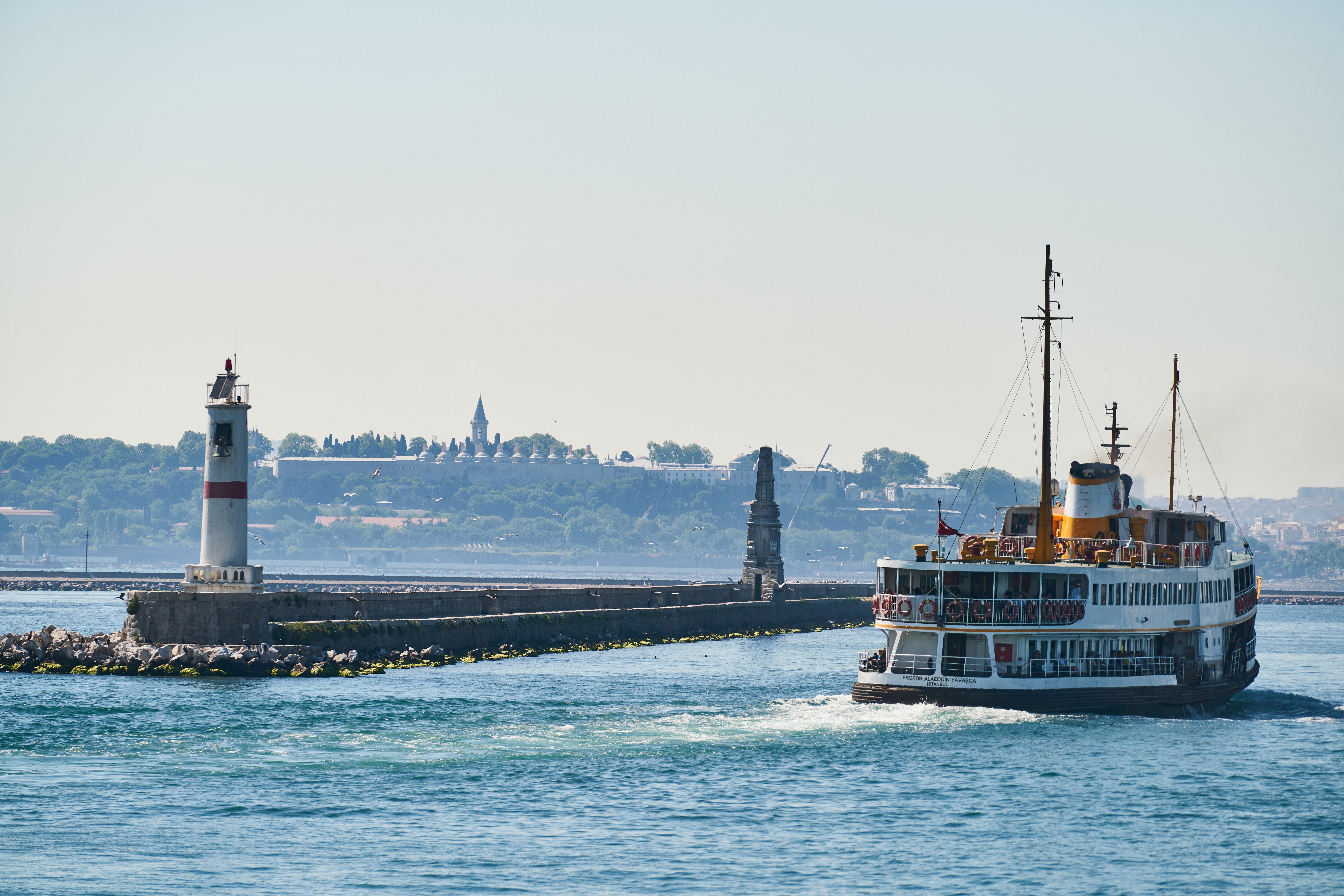 Ferryboat passing a lighthouse in Istanbul, Turkey HD Wallpaper