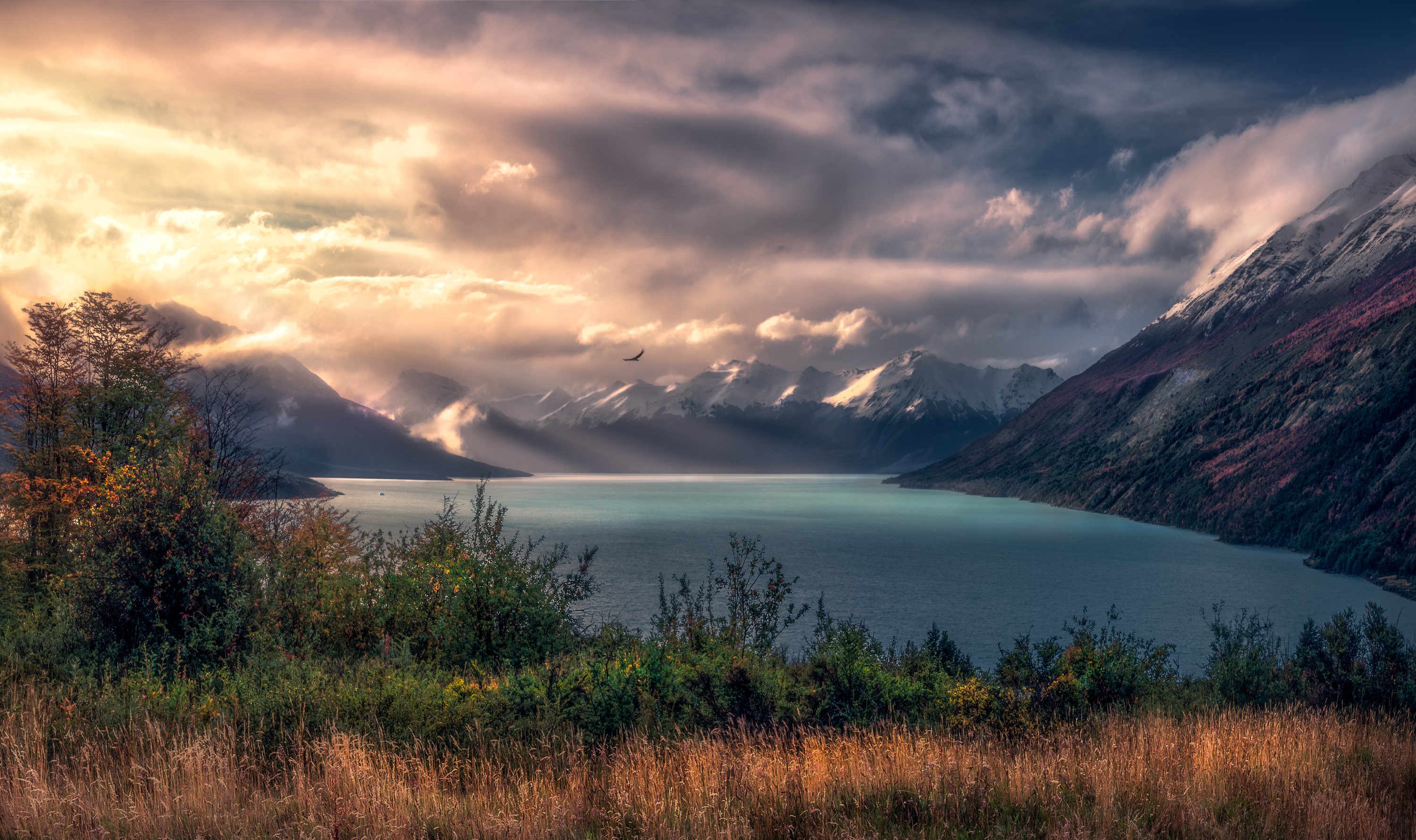 Lake and mountains with dramatic clouds and sunbeams HD Wallpaper