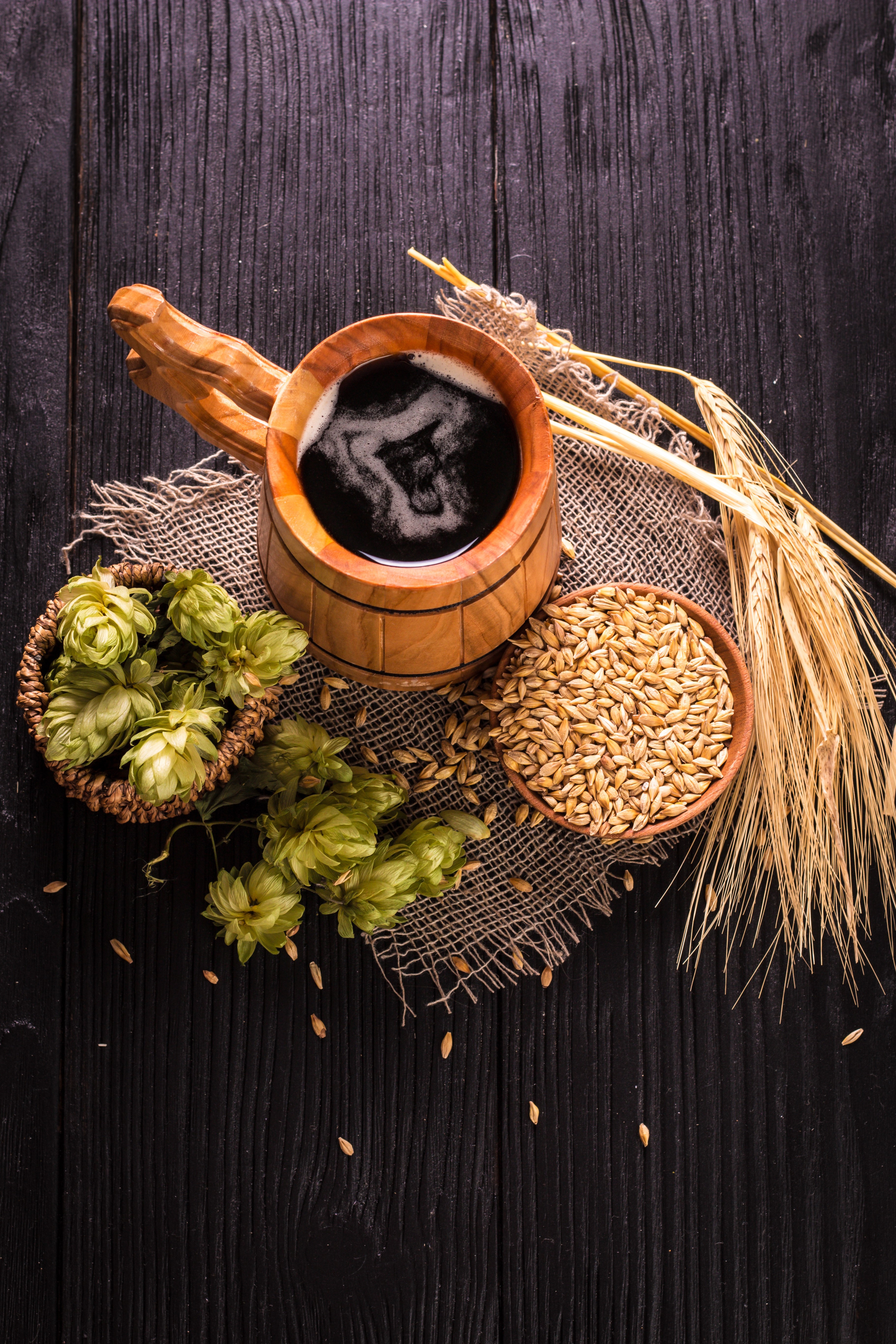 Beer mug with hops and barley on wood HD Phone Wallpaper
