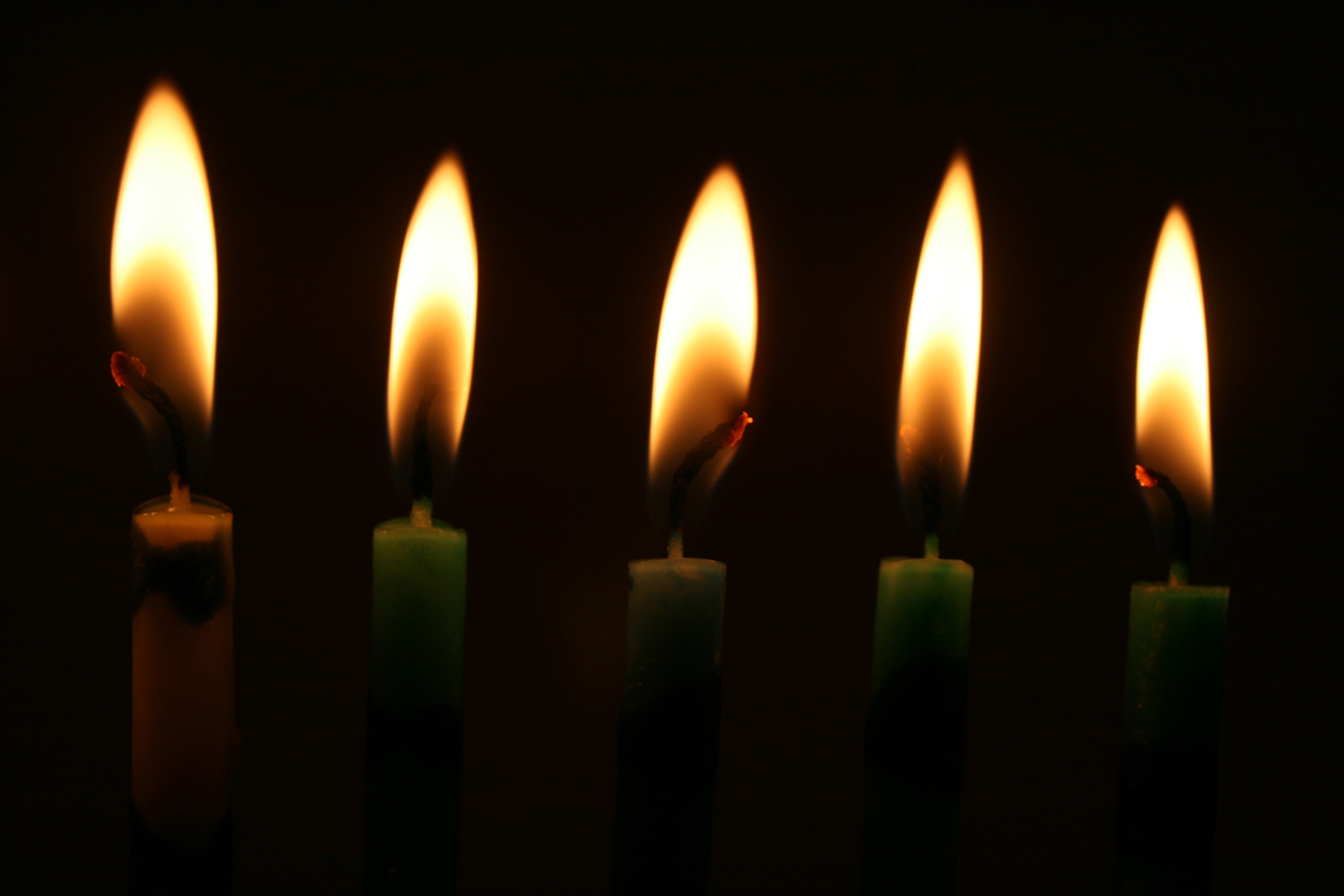 Five lit candles on a black background HD Wallpaper