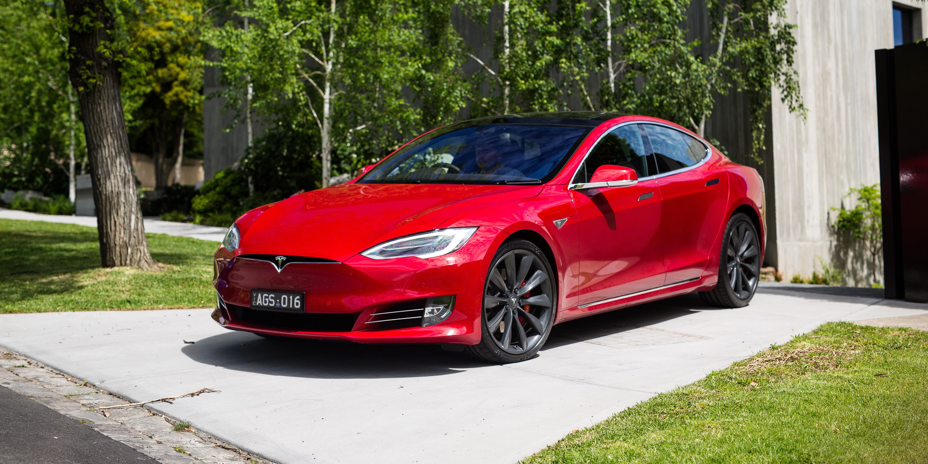 Red Tesla Model S P90D parked on driveway HD Wallpaper