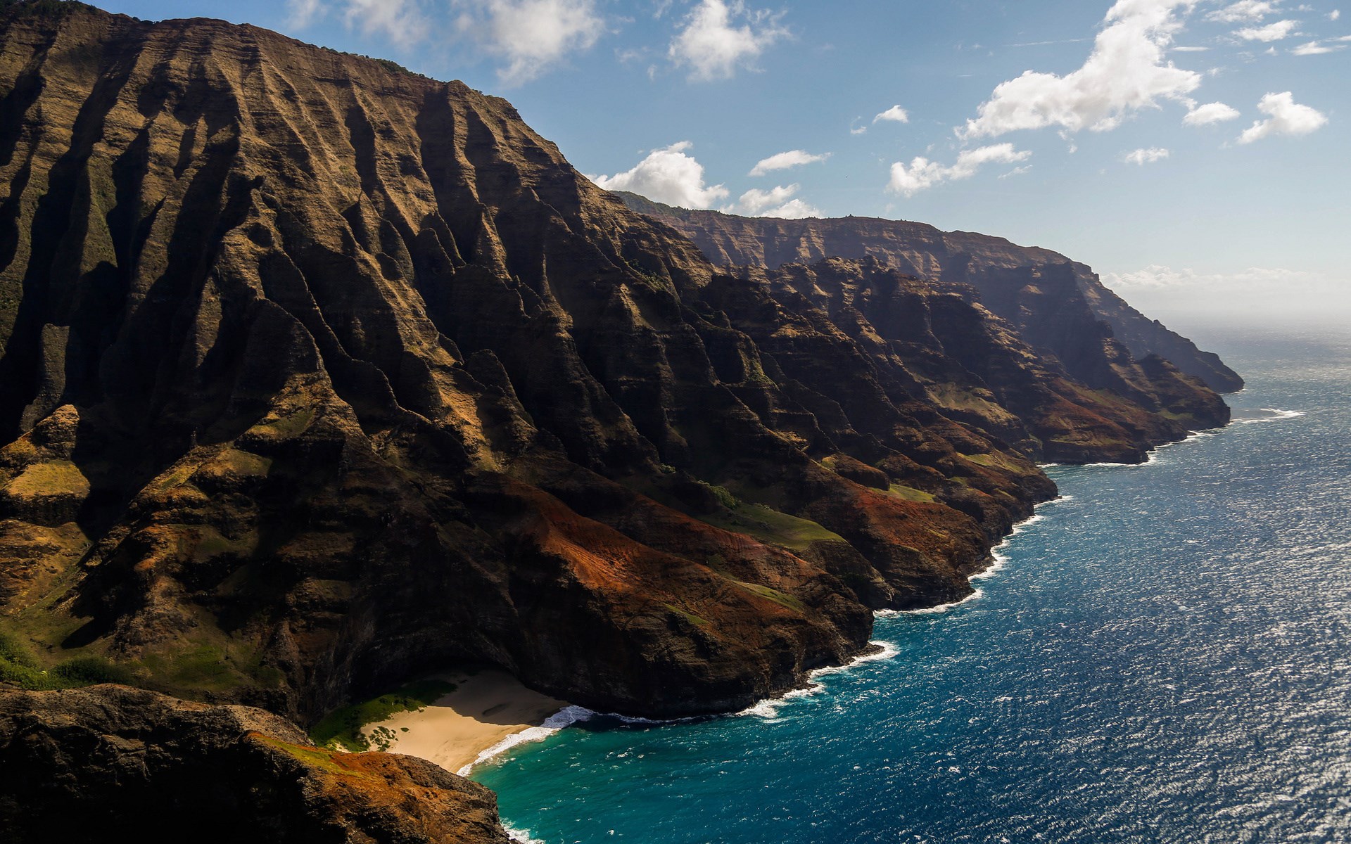 Rugged coastal cliffs meeting the ocean HD Wallpaper