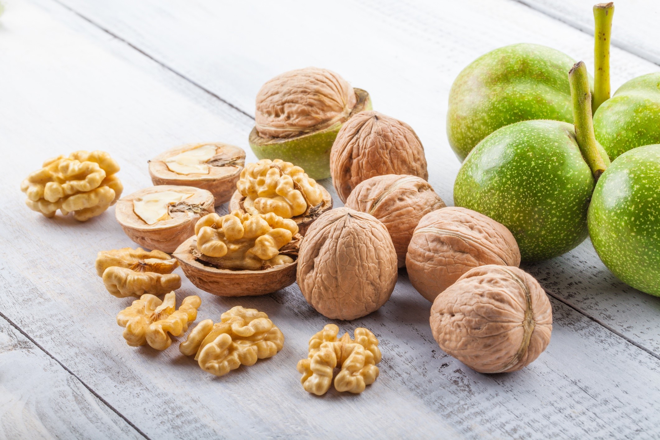 Walnuts and green walnuts on a wooden table HD Wallpaper