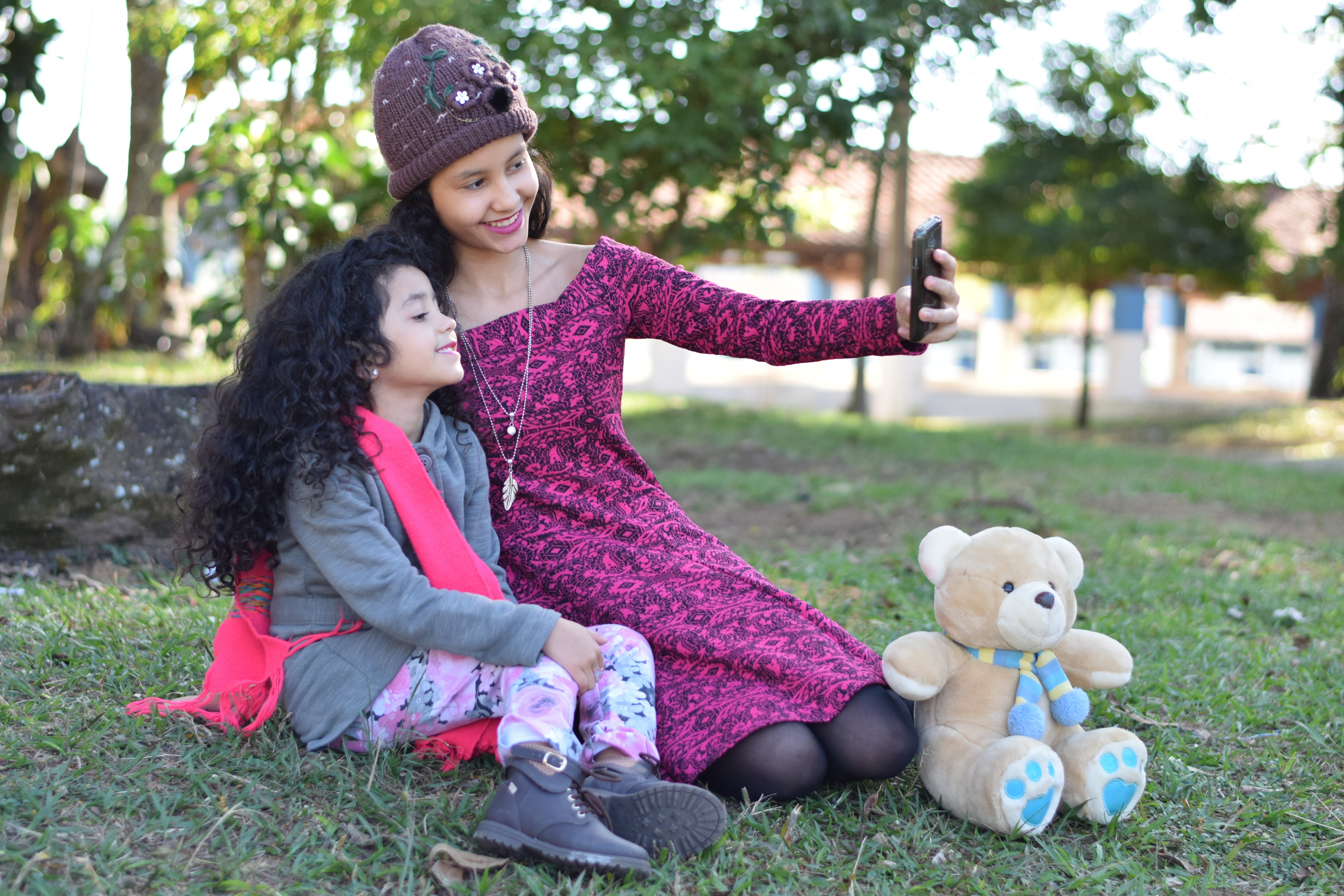 Two girls taking a selfie with a teddy bear HD Wallpaper